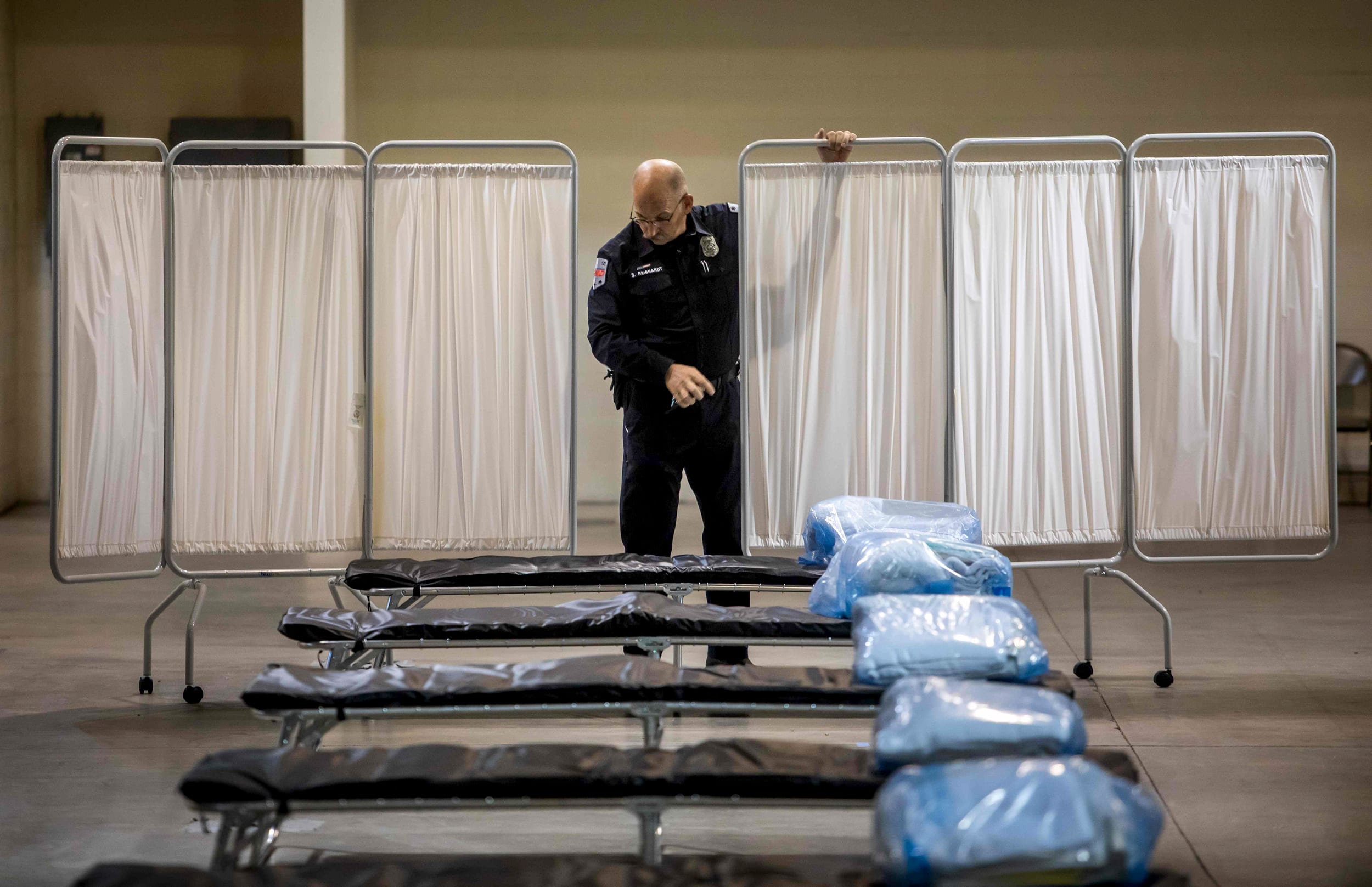 Image: A health public information officer looks at beds at a temporary hospital set up by the California National Guard in Indio on March 29, 2020.
