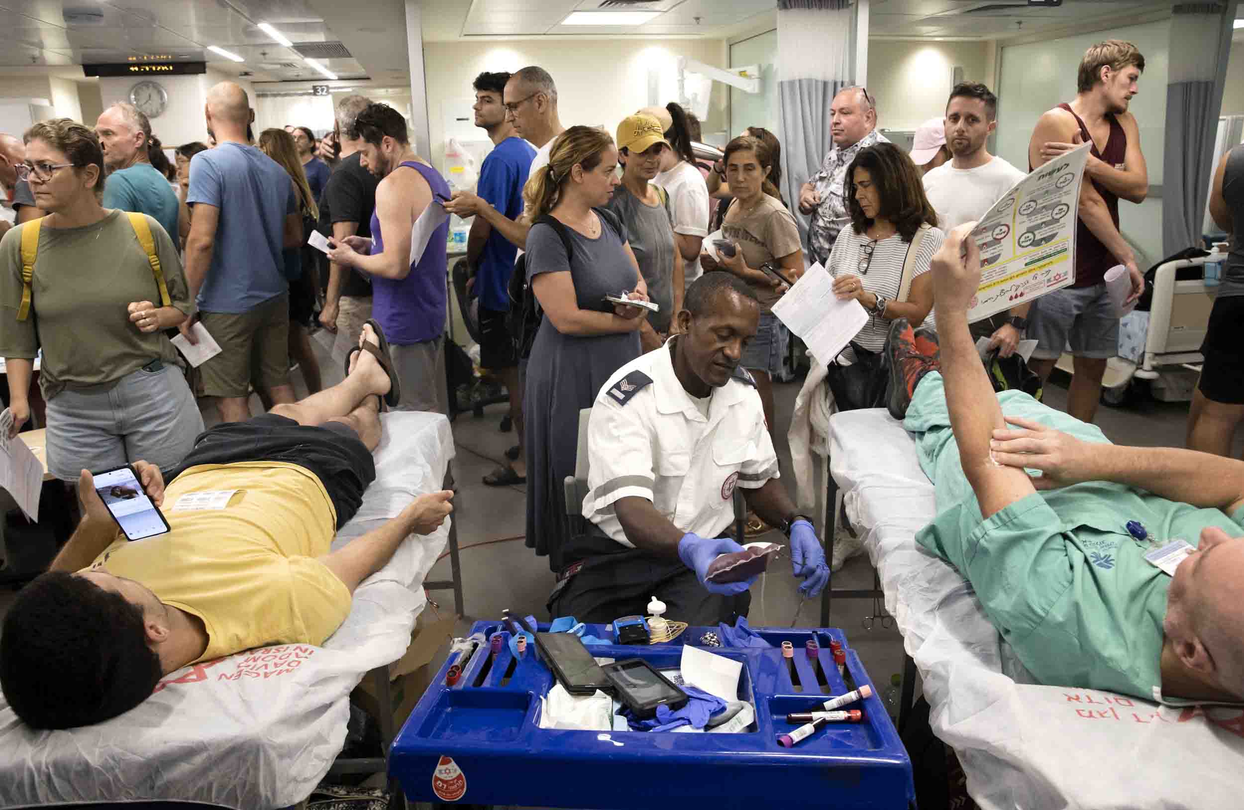 Image; Israeli's line up to donate blood at Tel Aviv's Sourasky Medical Center on Saturday.