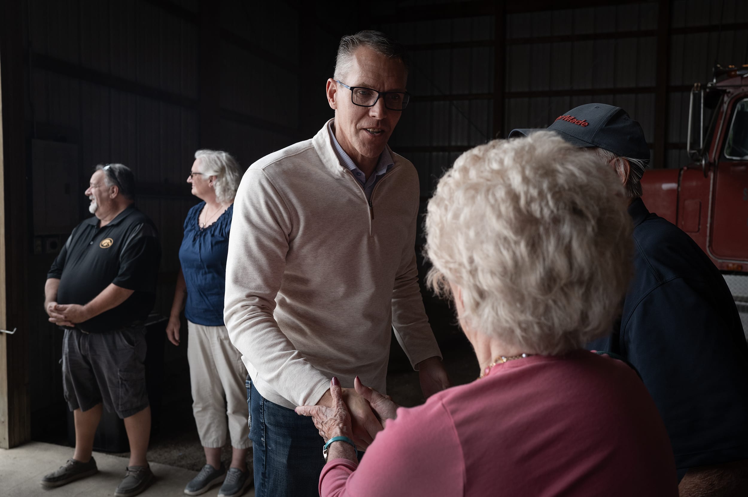 Randy Feenstra shaking hands with an elderly woman during a campaign event.