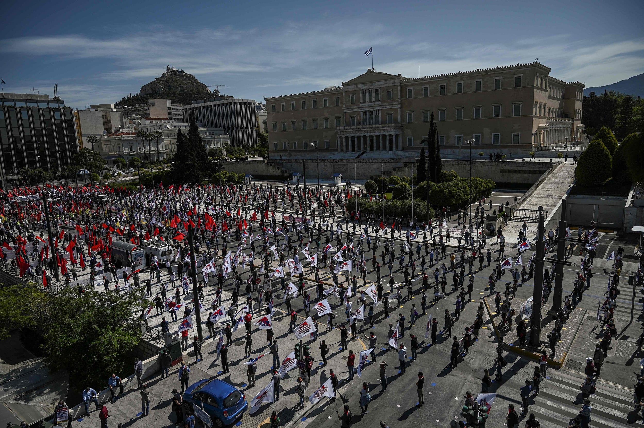 Image: Members of the Greek Labour Union (PAME), wearing protective masks and respecting the social distances against the spread of the novel coronavirus, COVID-19, protest in front of the Greek Parliament during the Labour Day demonstration in Athens