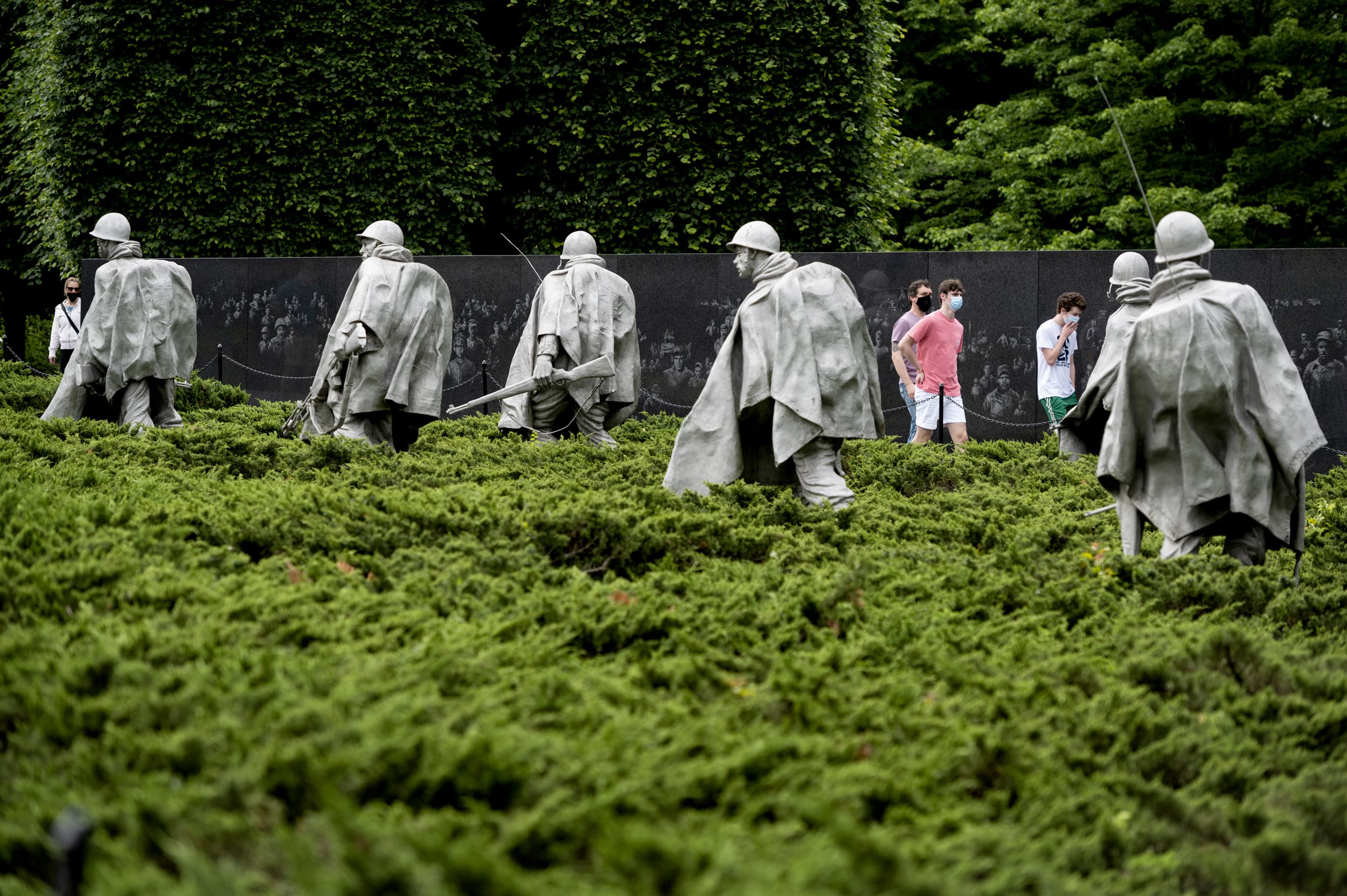 Image: Visitors wear face masks at the Korean War Veterans Memorial on May 25, 2020.