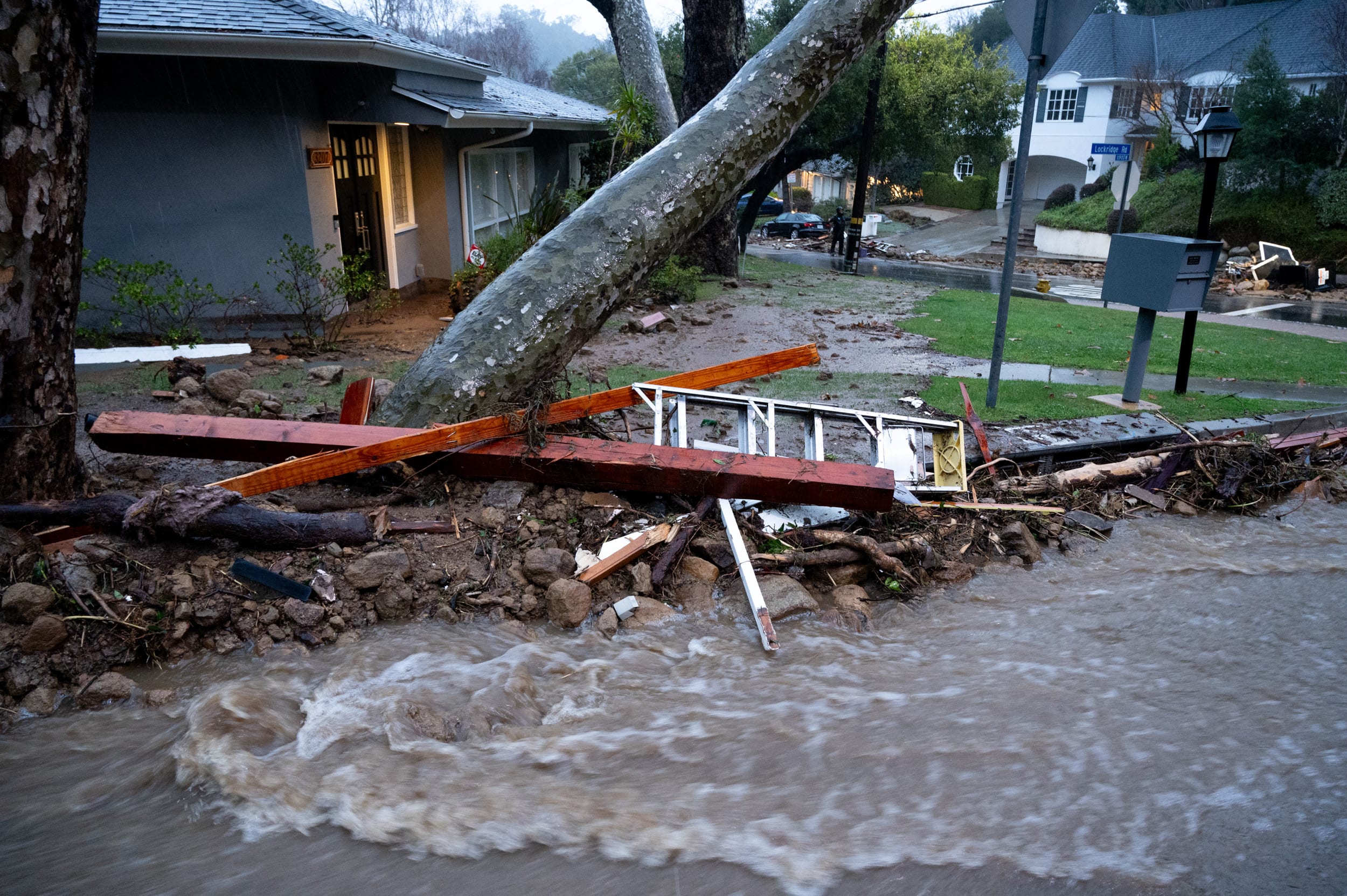Debris flows along a road in Studio City in Los Angeles.