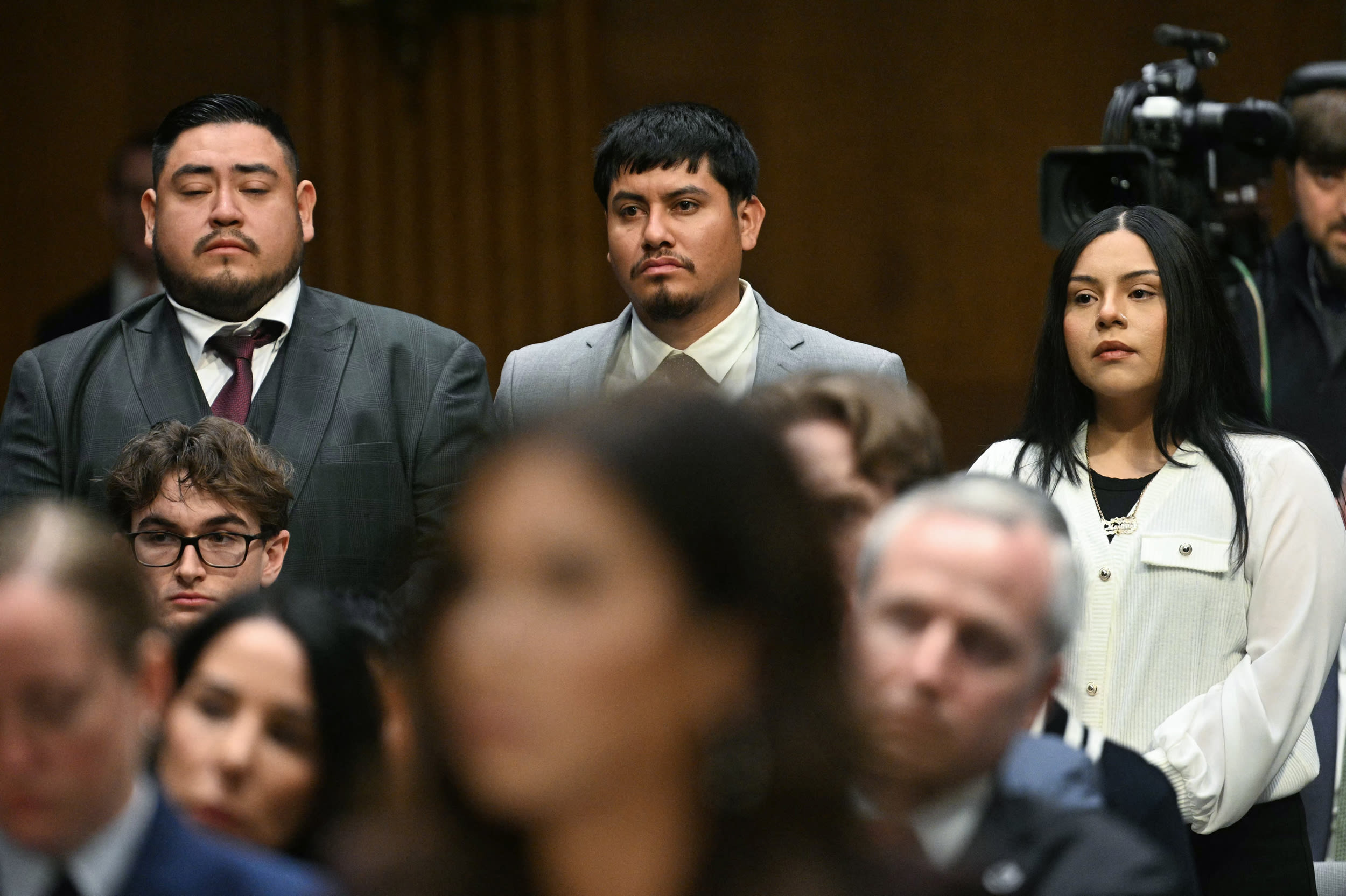 From left, Javier Ramirez, Leonardo Garcia Venegas and Marimar Martinez, American citizens who were previously detained by federal immigration officers, stand as they are recognized during a Senate Judiciary Committee hearing