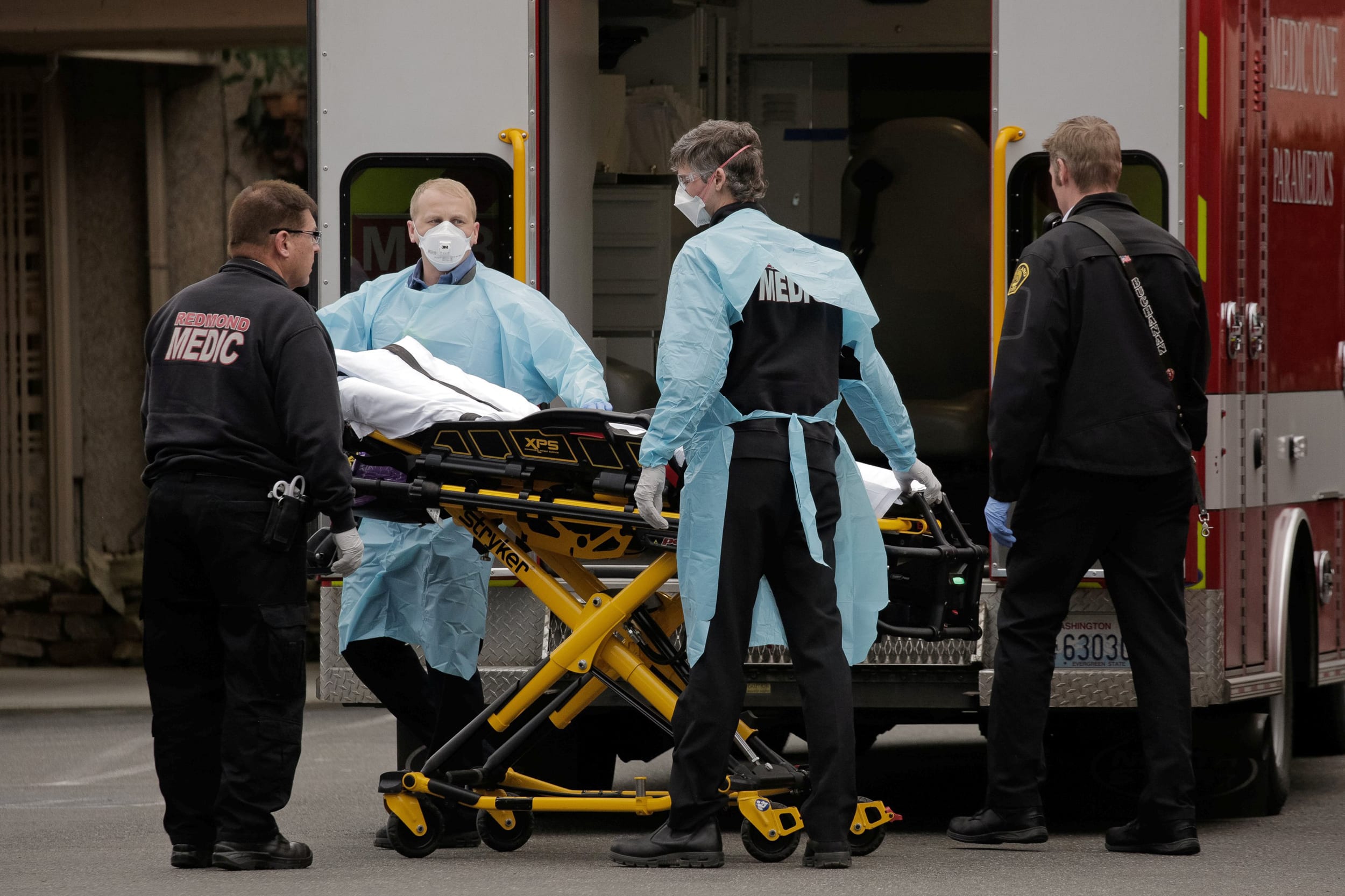Image: Medics prepare to transfer a patient on a stretcher to an ambulance at the Life Care Center of Kirkland, the long-term care facility linked to the two of three confirmed coronavirus cases in the state, in Kirkland