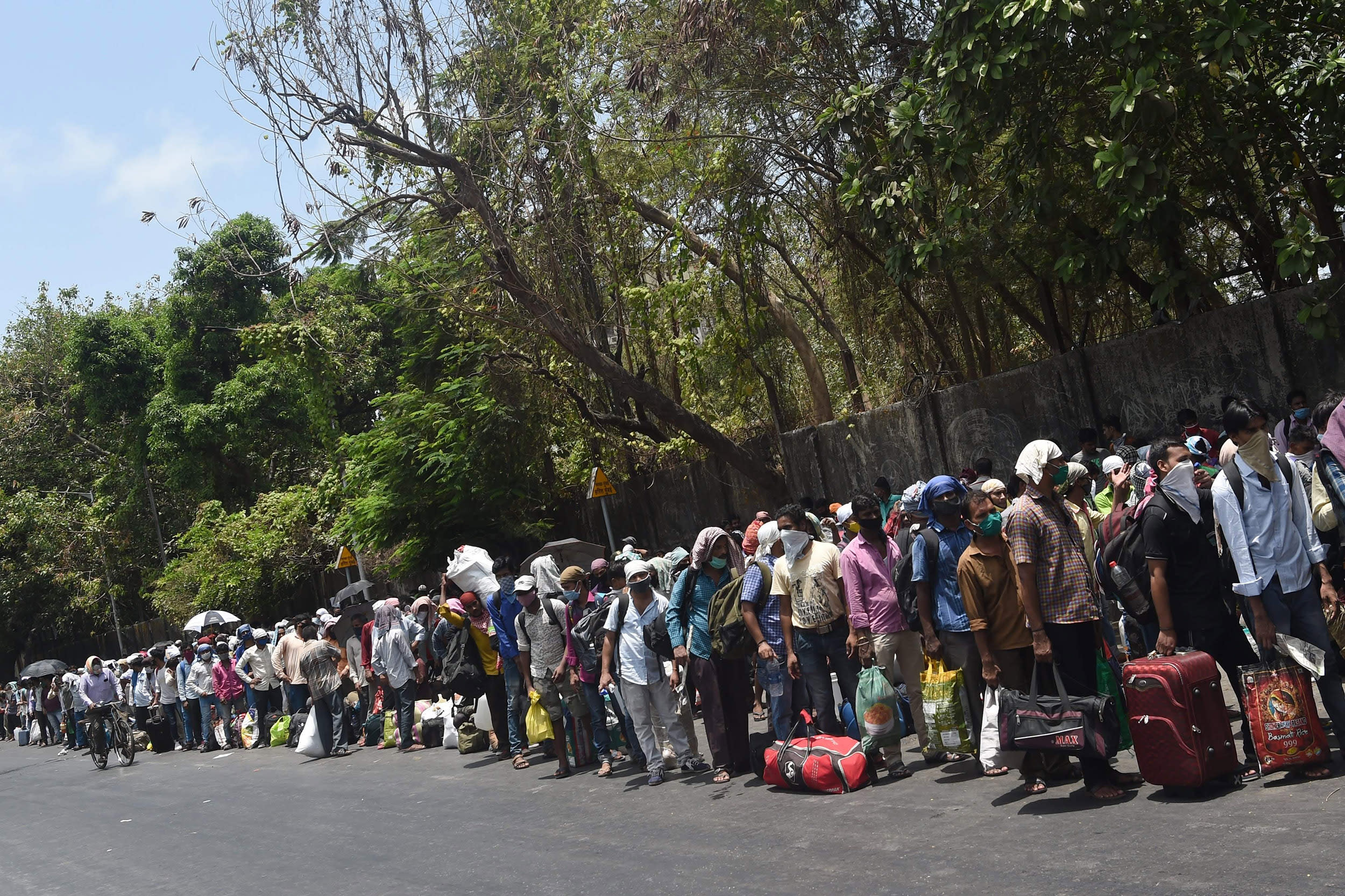 Image: Migrant workers queue outside the Chhatrapati Shivaji Maharaj Terminus railway station to return to their hometowns after the government eased a nationwide lockdown as a preventive measure against the COVID-19 coronavirus, in Mumbai