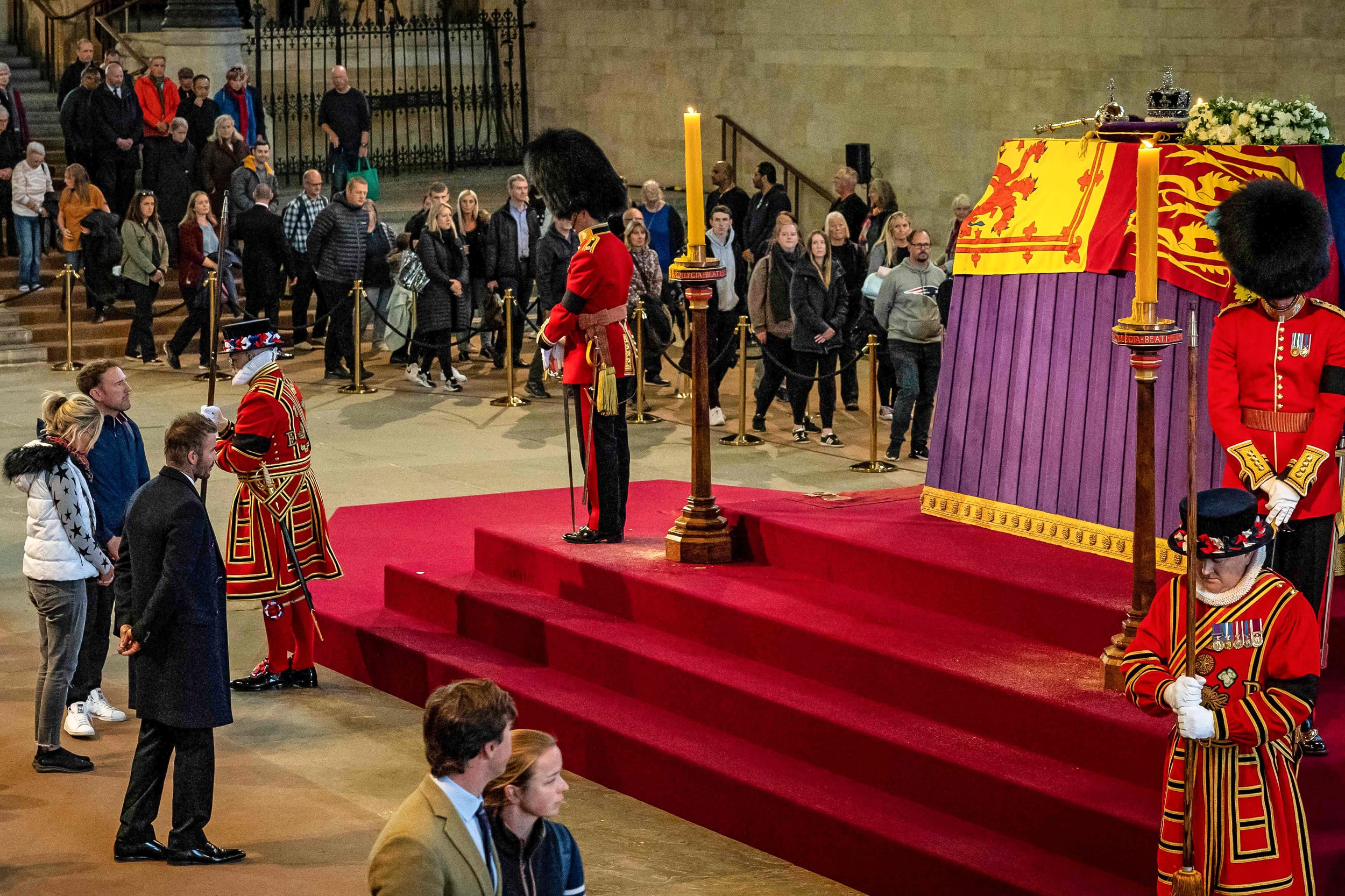Image: David Beckham pays his respects as he passes the coffin of Queen Elizabeth II, lying in state inside Westminster Hall, at the Palace of Westminster in London on Sep. 16, 2022.