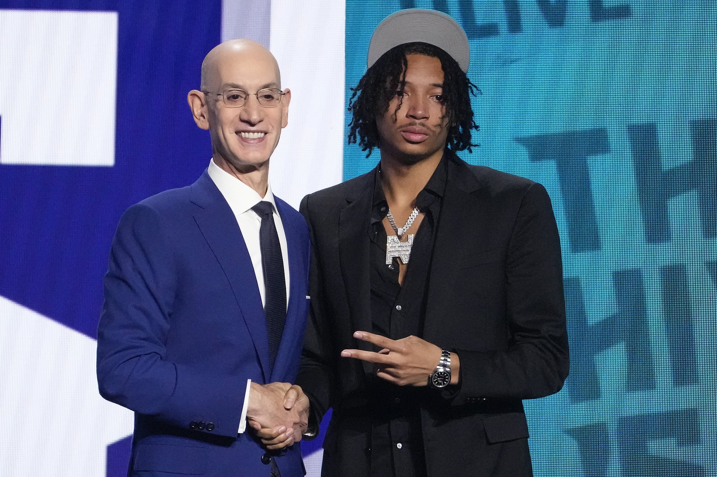 Nick Smith Jr. poses for a photo with NBA Commissioner Adam Silver after being selected 27th overall by the Charlotte Hornets during the NBA basketball draft, Thursday, June 22, 2023, in New York. (AP Photo/John Minchillo)