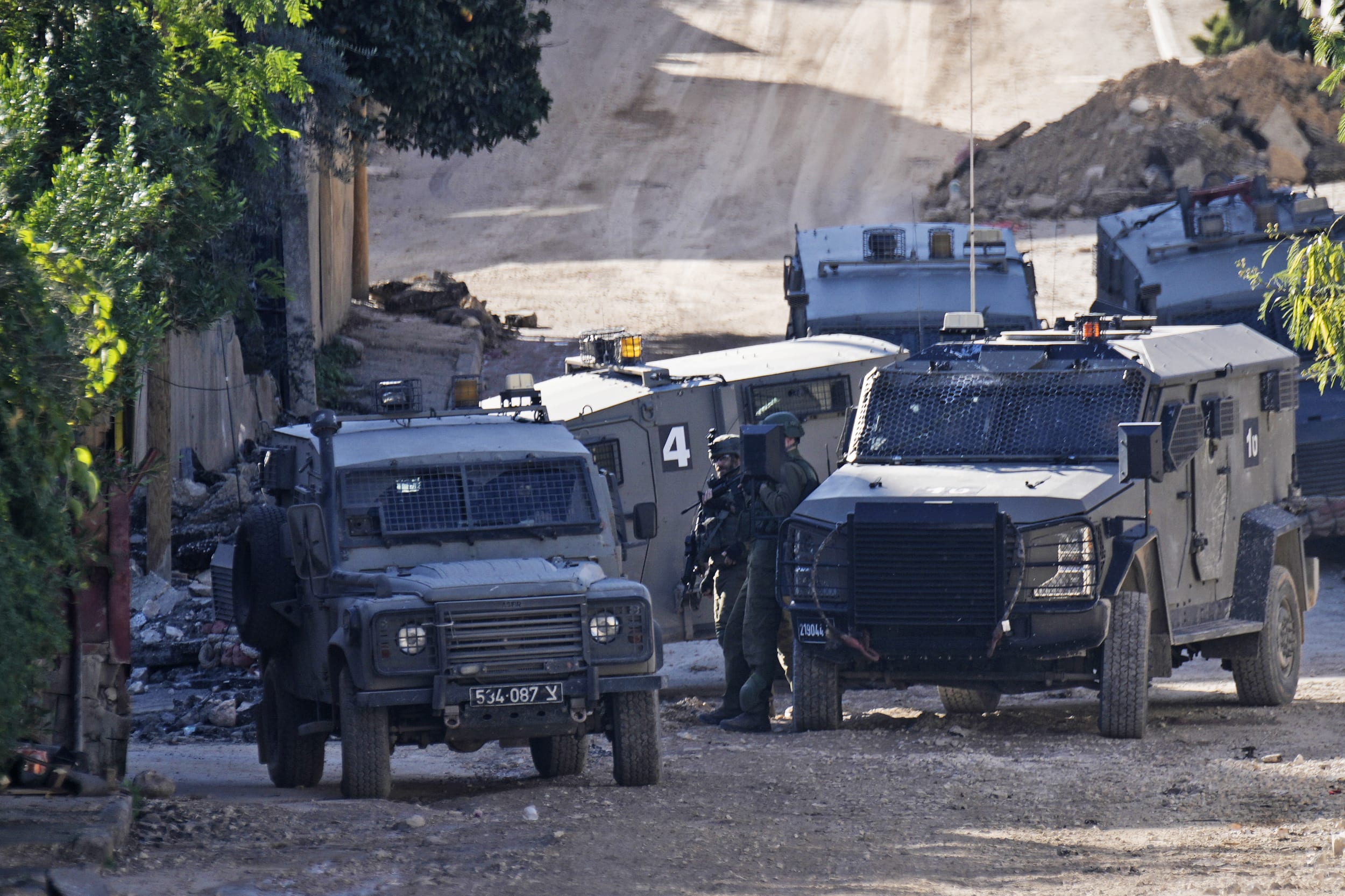 Members of the Israeli military take positions during a raid on the Jenin refugee camp in the occupied West Bank on Wednesday, Nov. 29, 2023.
