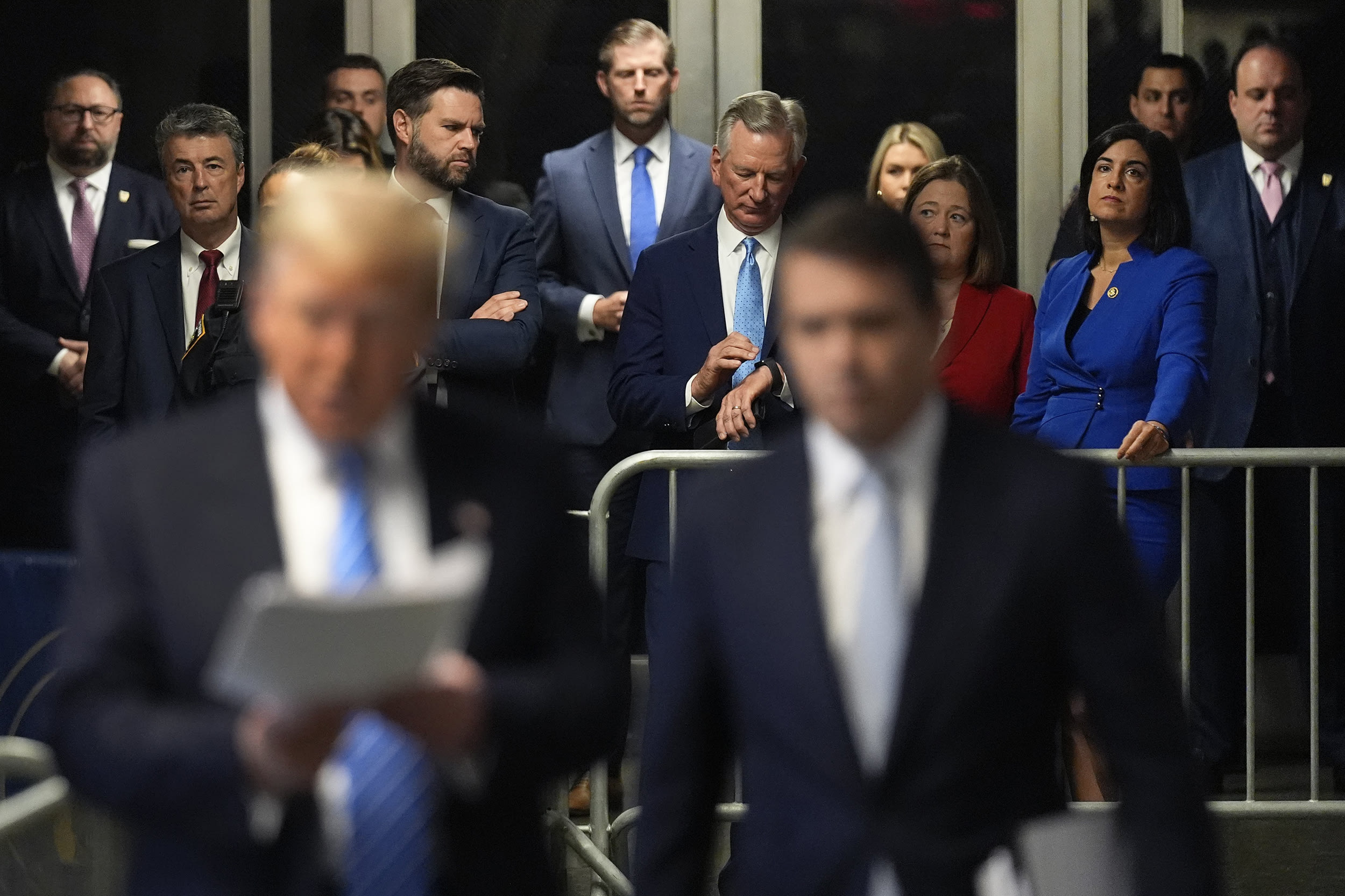 Alabama Attorney General, Steve Marshall, second from left, Sen. J.D. Vance, R-Ohio, Eric Trump, Sen. Tommy Tuberville, R-Ala., Iowa Attorney General Brenna Bird and Sen. Nicole Malliotakis, R-N.Y., listen as former President Donald Trump speaks ahead of court on May 13, 2024 in New York City.