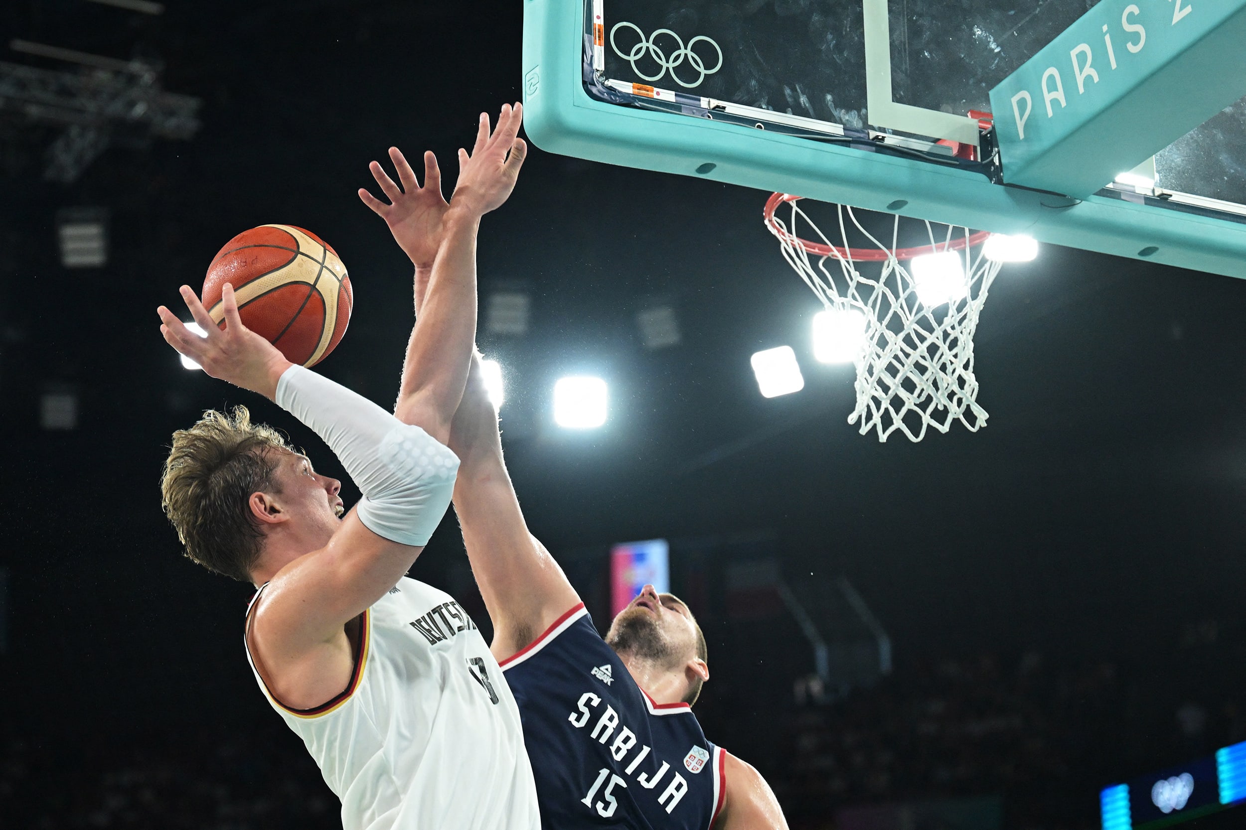 Germany's #09 Franz Wagner goes to the basket past Serbia's #15 Nikola Jokic in the men's Bronze Medal basketball match between Germany and Serbia during the Paris 2024 Olympic Games at the Bercy Arena in Paris on August 10, 2024.
