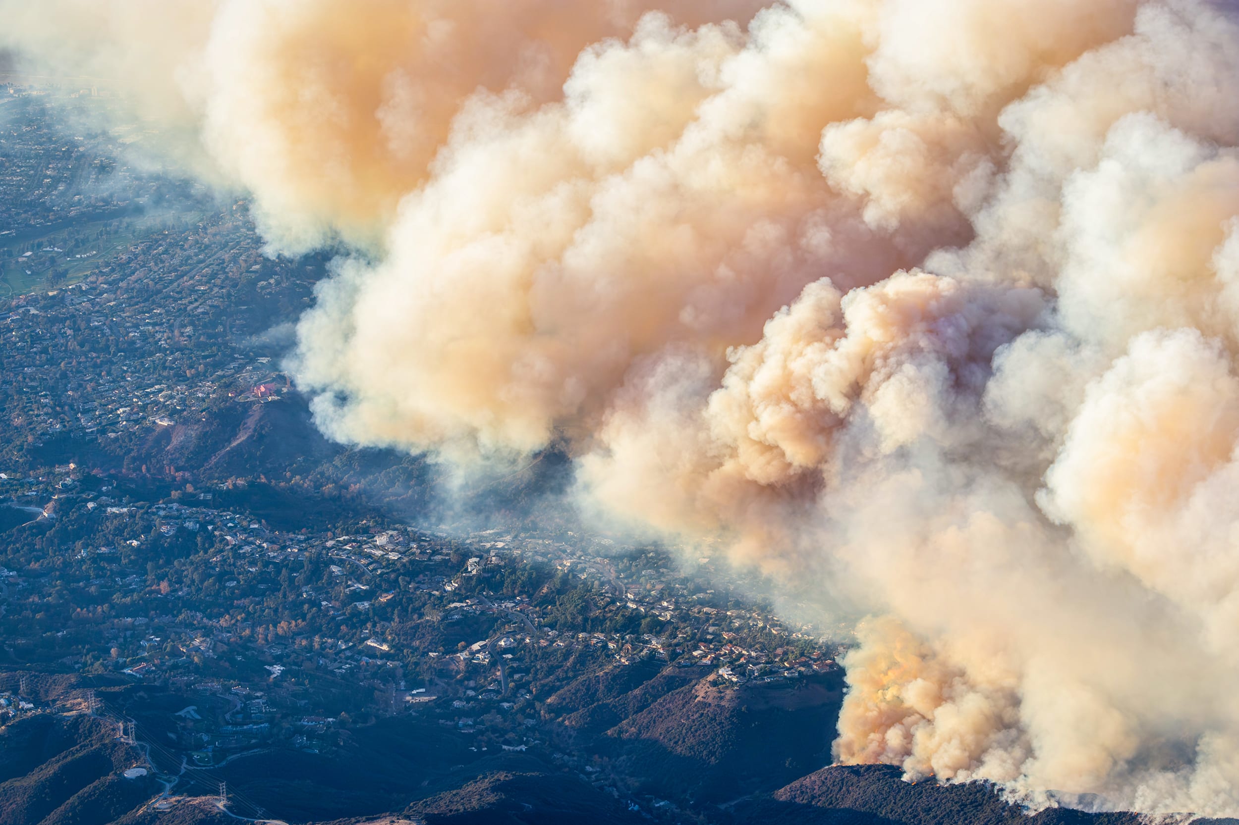 Helicopter aerial view of the Palisades fire burning near Mountain Gate Country Club.