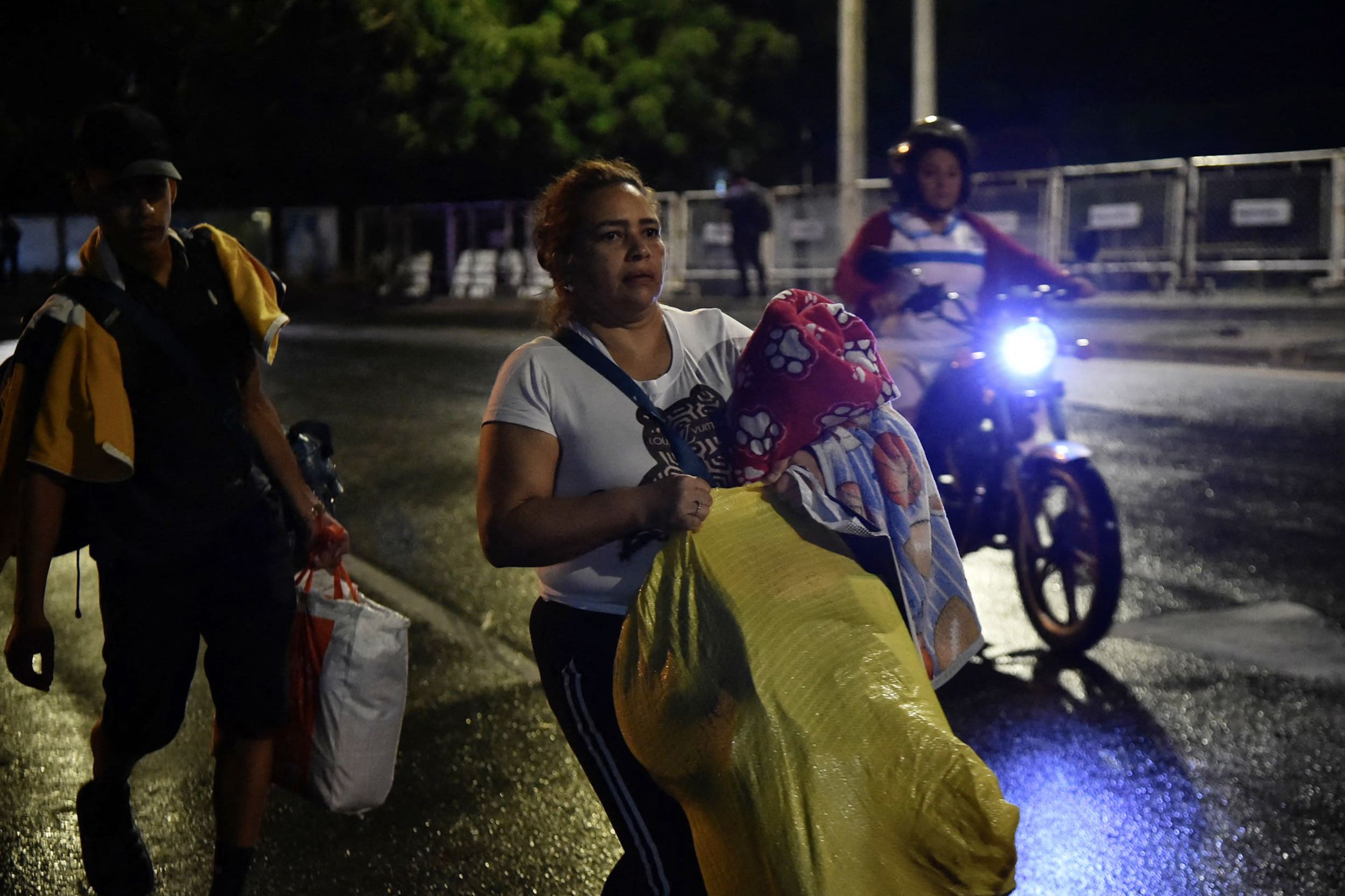 Venezuelans leaving their country arrive at the border crossing in Cucuta, Colombia, on January 3, 2026, after US forces had captured Venezuelan leader Nicolas Maduro after launching a "large scale strike" on the South American country.