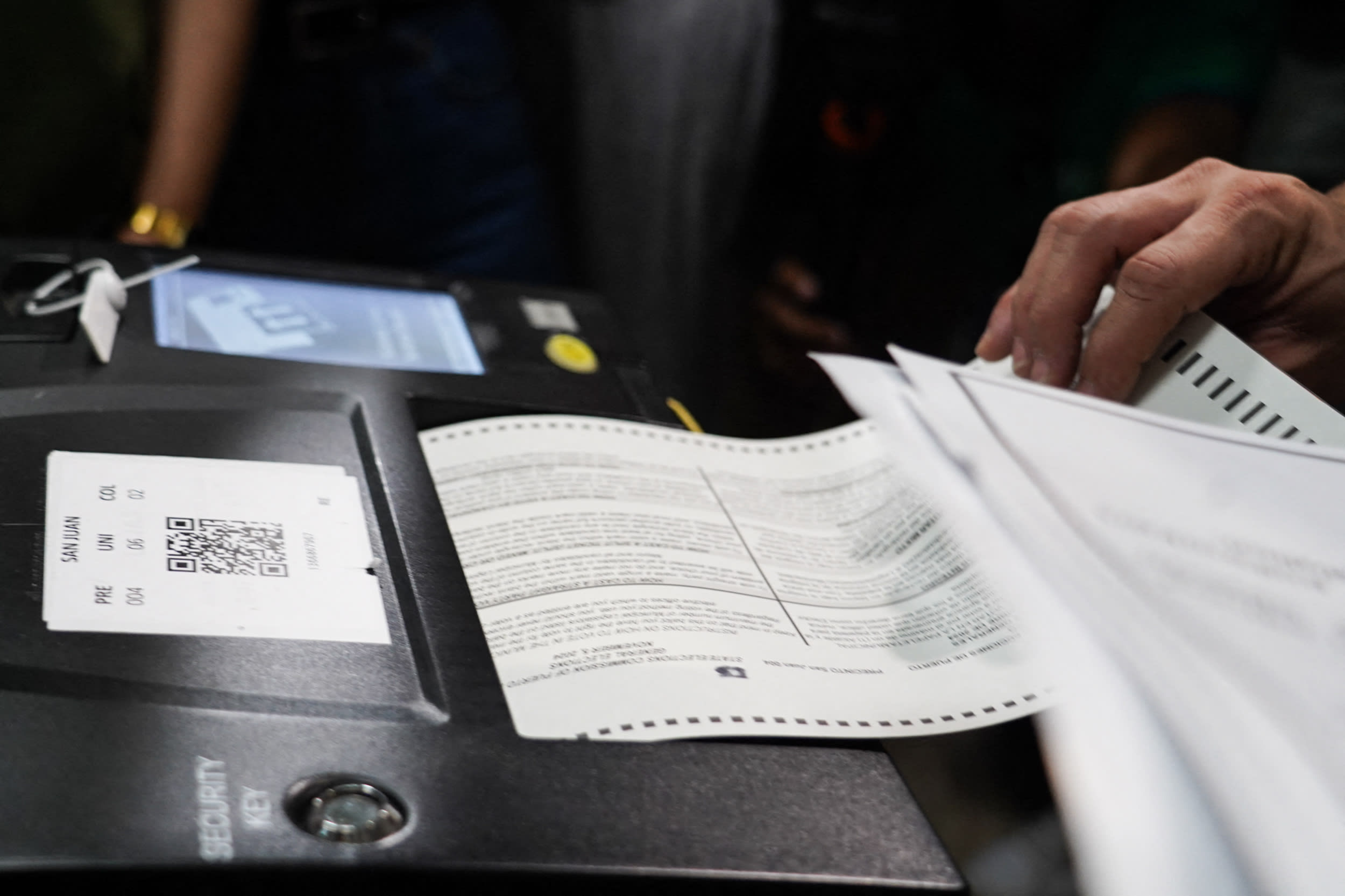 Voters fill out their ballots at a polling place on Election Day in San Juan, Puerto Rico.