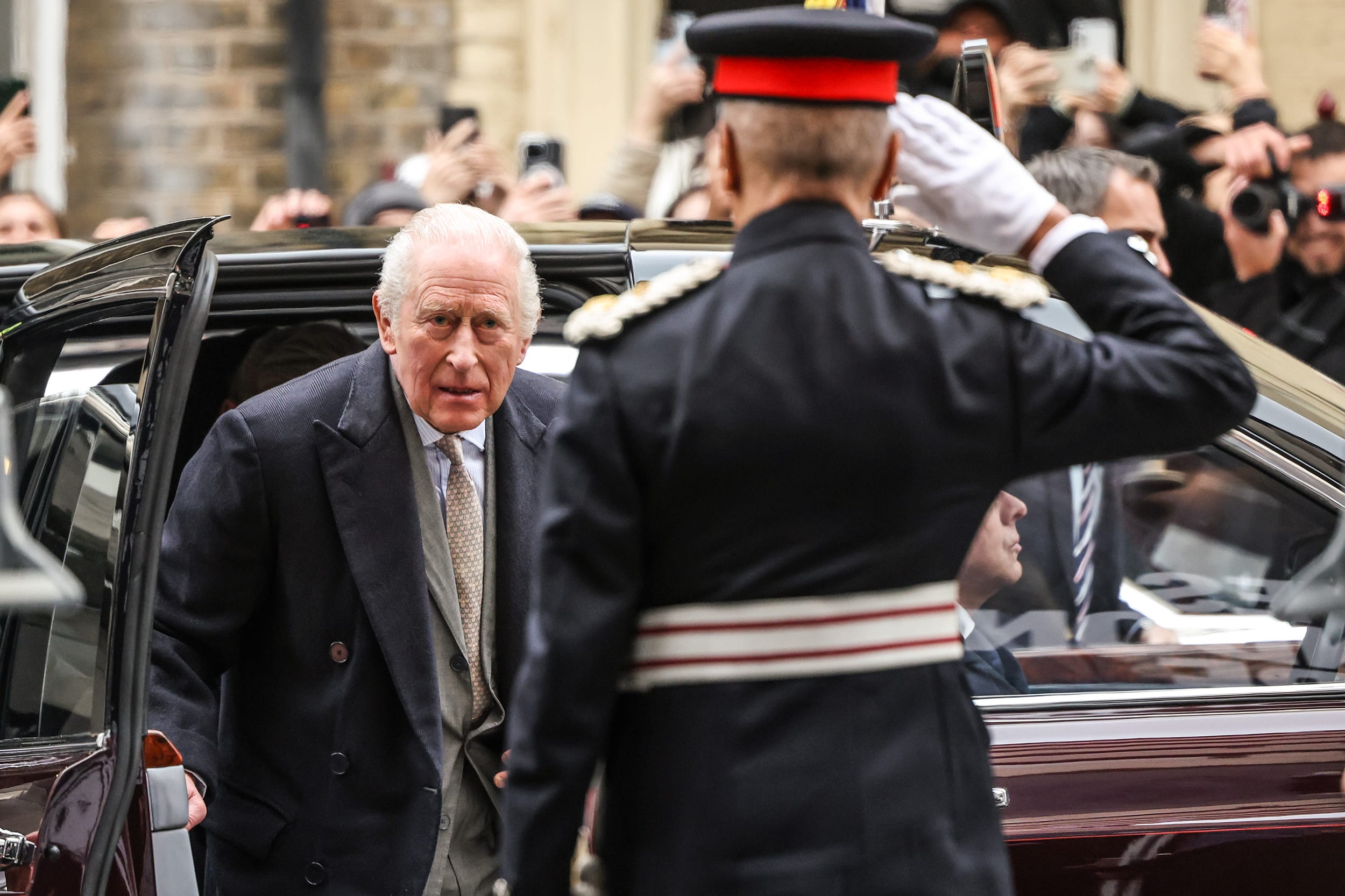 King Charles III exits a vehicle to attend the opening show of London fashion week.