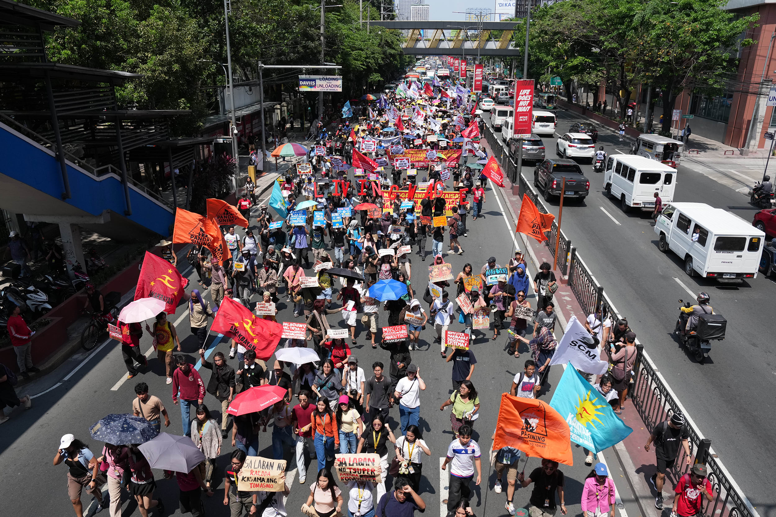 Protesters march during a rally by transport workers and activists protesting the rise in oil prices on Friday, March 27, 2026, near the Malacanang presidential palace in Manila, Philippines. 