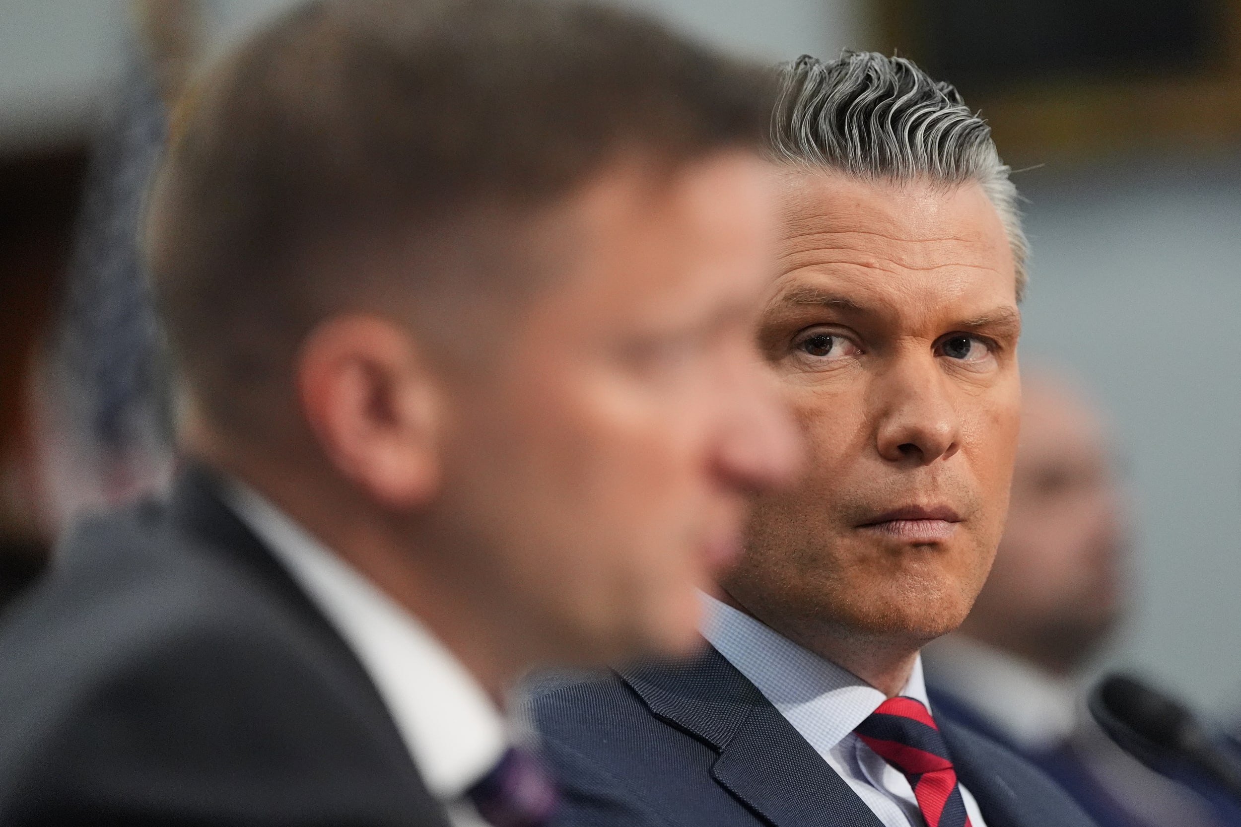 Defense Secretary Pete Hegseth watches as acting Under Secretary of Defense and Comptroller Jules Hurst III testifies 