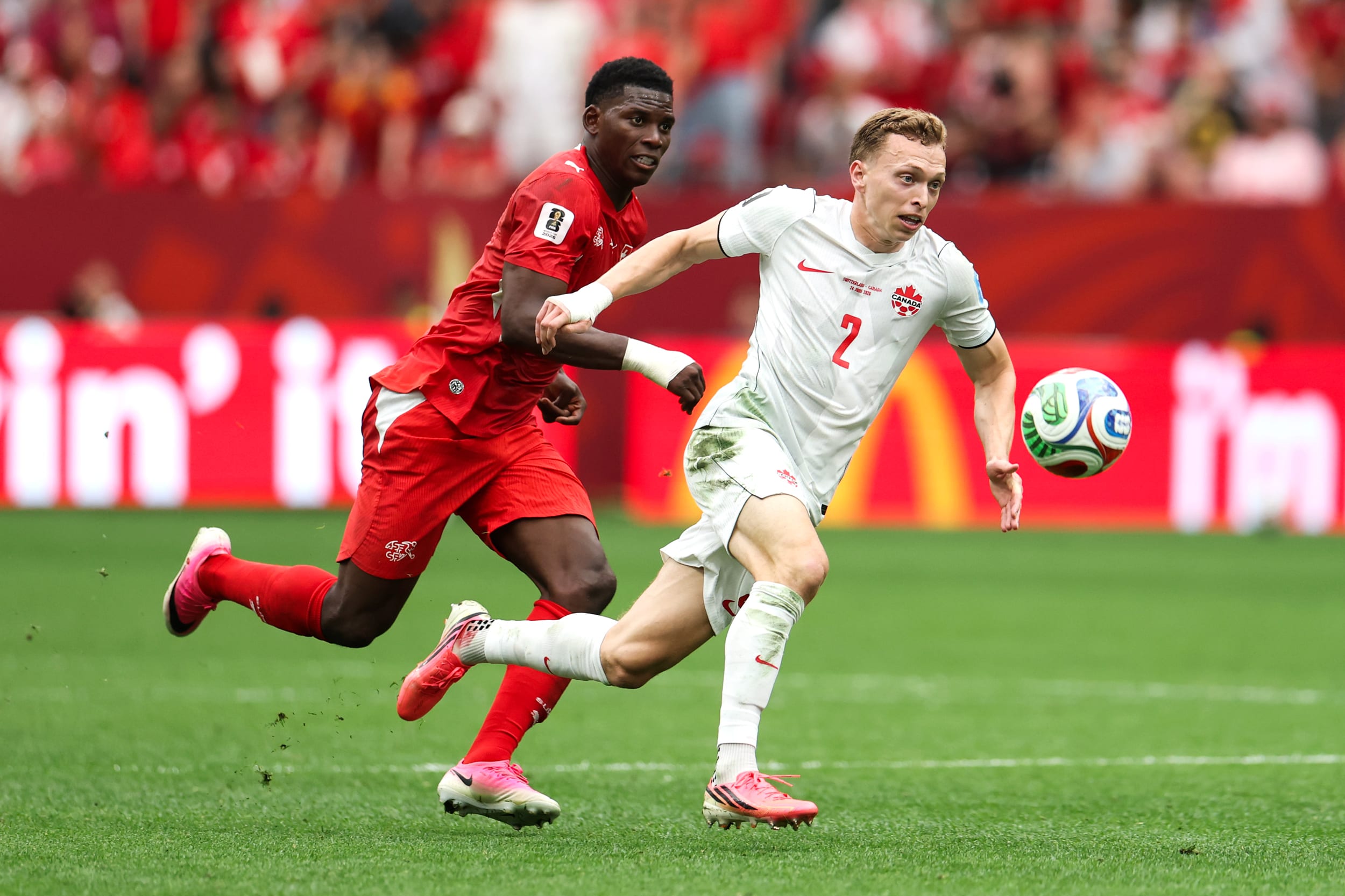 Alistair Johnston #2 of Canada controls the ball against Breel Embolo #7 of Switzerland during the FIFA World Cup 2026 Group B match between Switzerland and Canada at BC Place Vancouver on June 24, 2026.