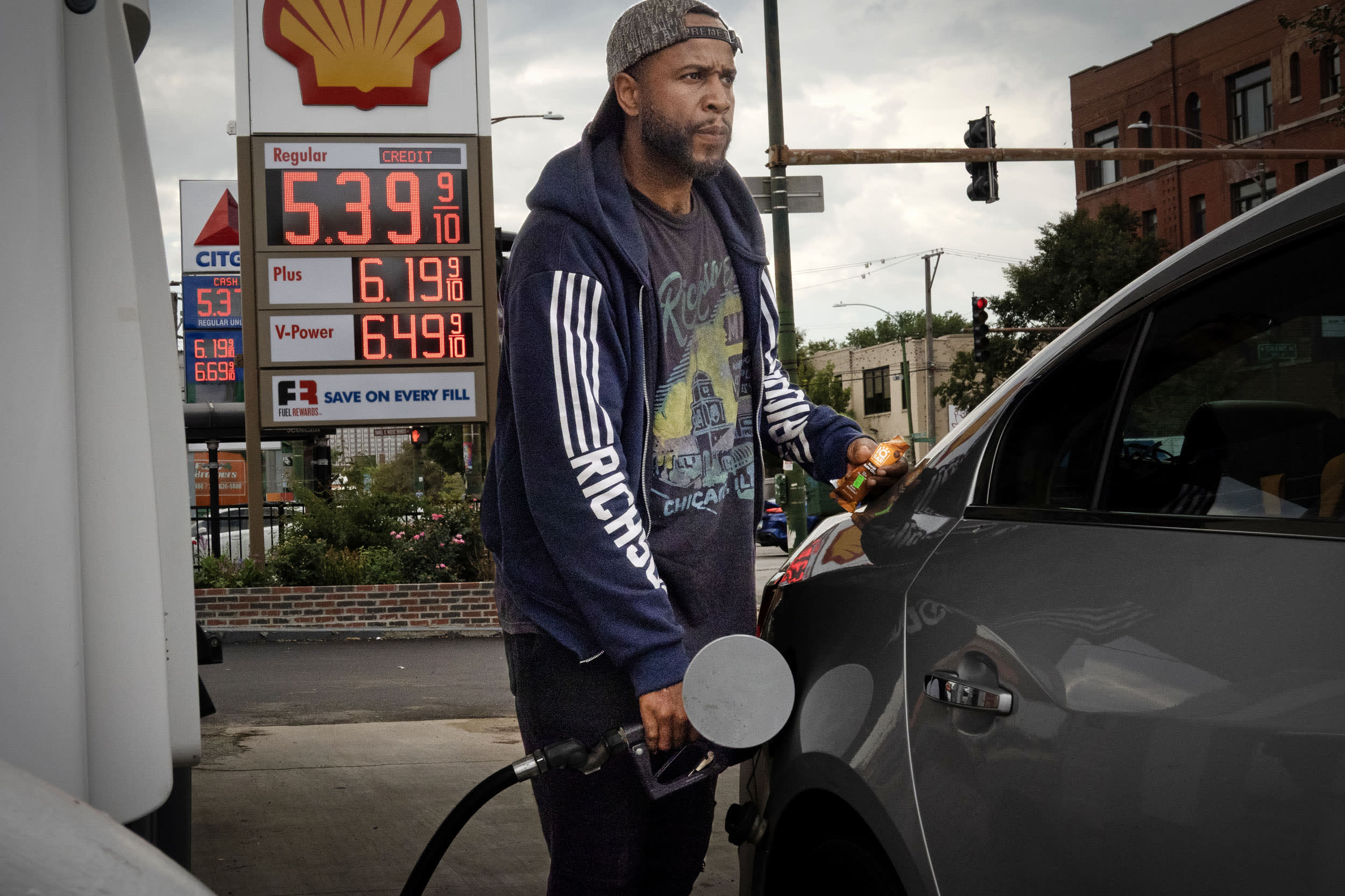 Driver fills his car with gas