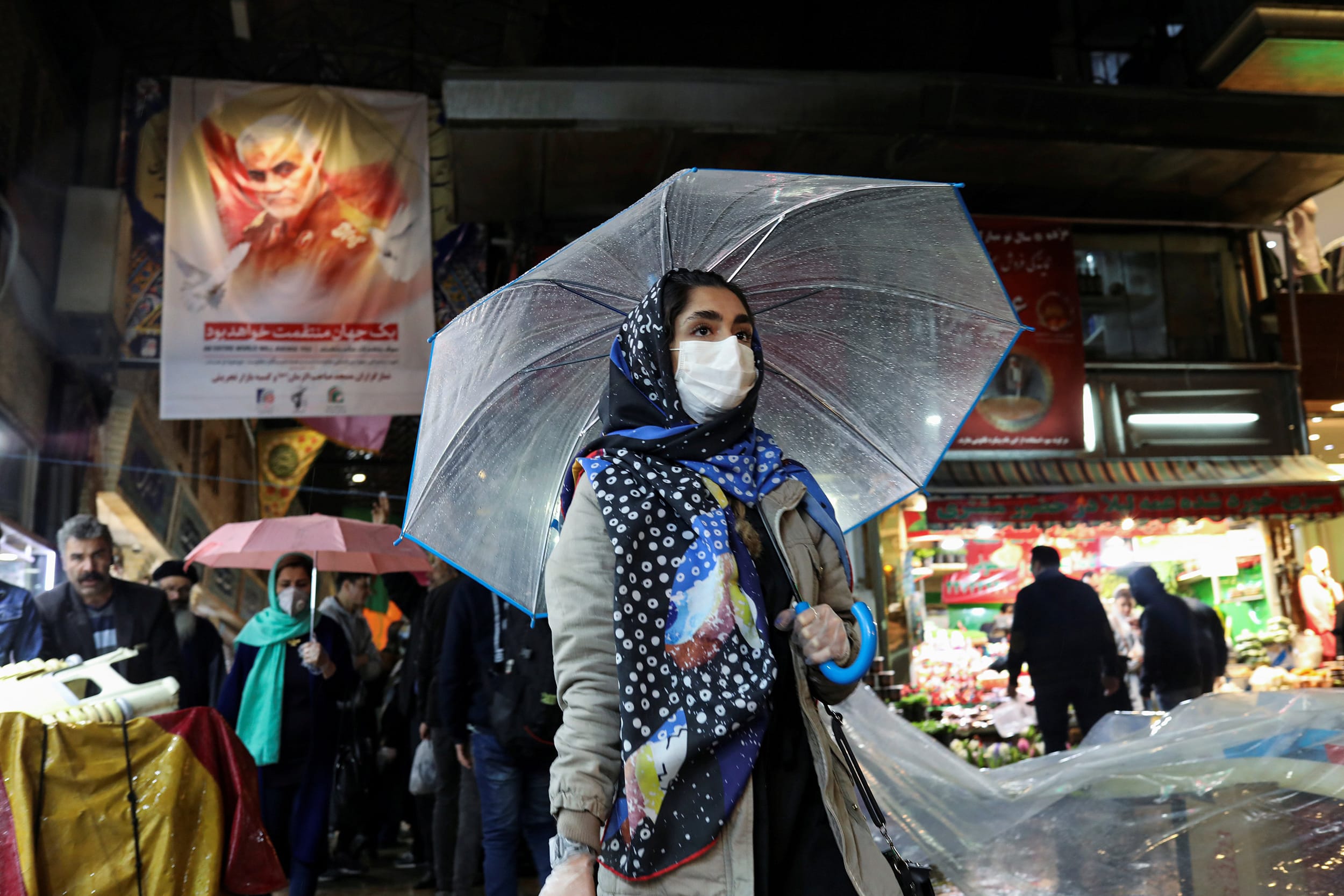 Image: An Iranian woman wears a protective face mask and gloves, amid fear of coronavirus disease (COVID-19), as she walks at Tajrish market, ahead of the Iranian New Year Nowruz, March 20, in Tehran