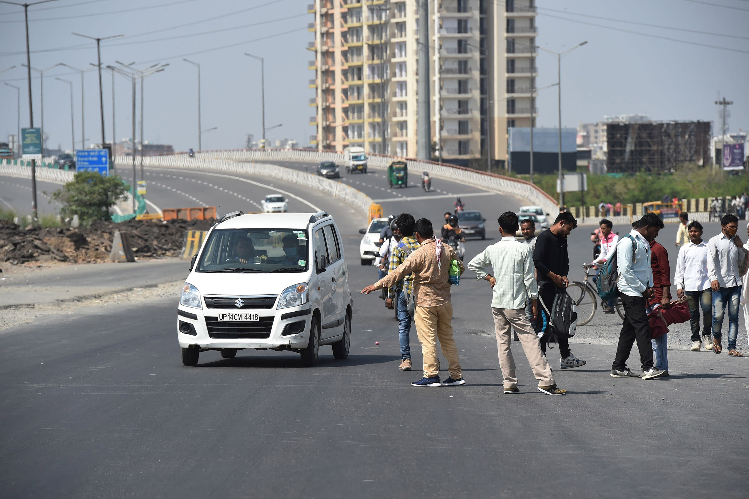 Image: People wait for transportation along the Delhi-Meerut Expressway following a lockdown order by Delhi's government and some districts of Uttar Pradesh.