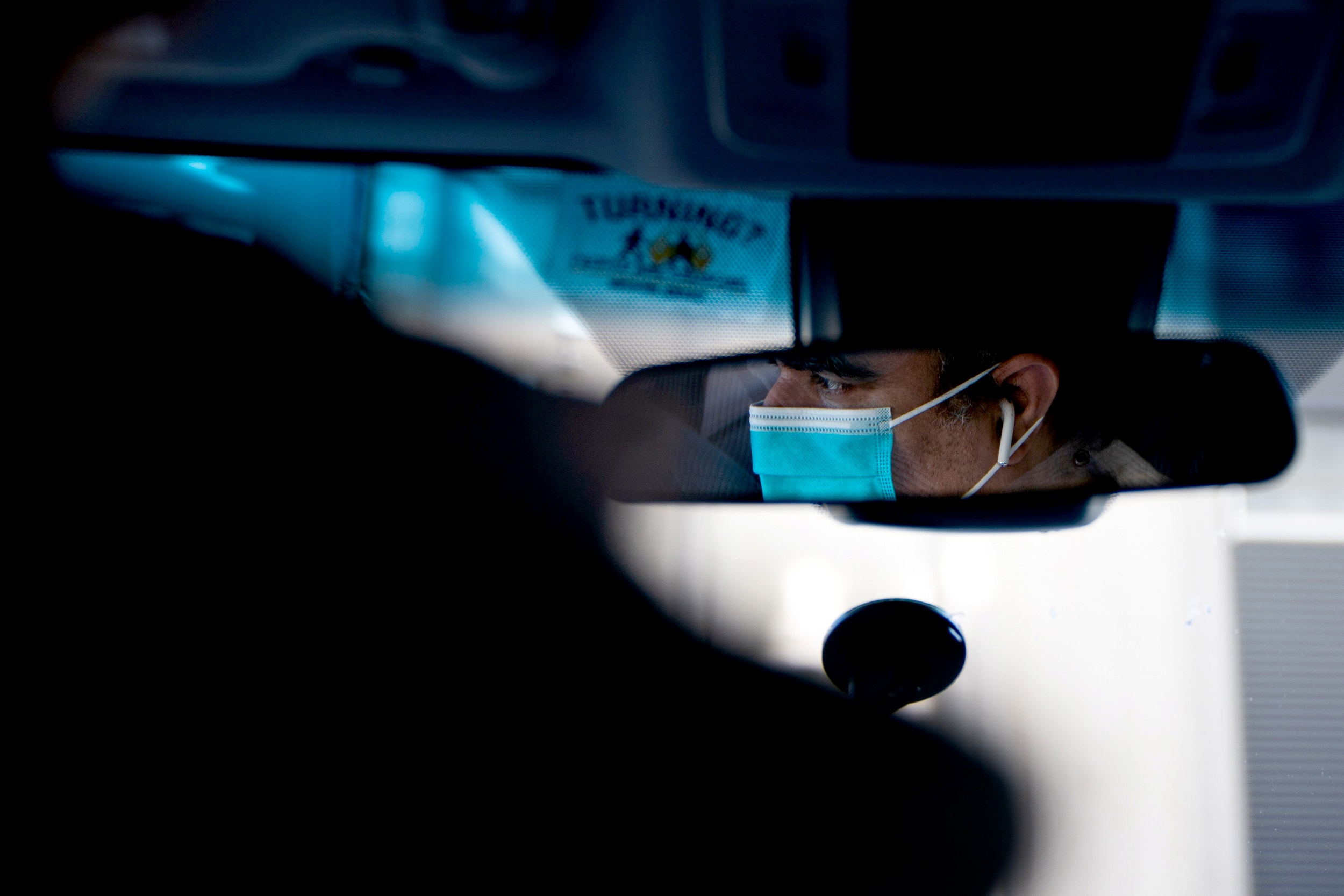 Image: An Uber driver wears a surgical mask while driving in Manhattan on March 15, 2020.