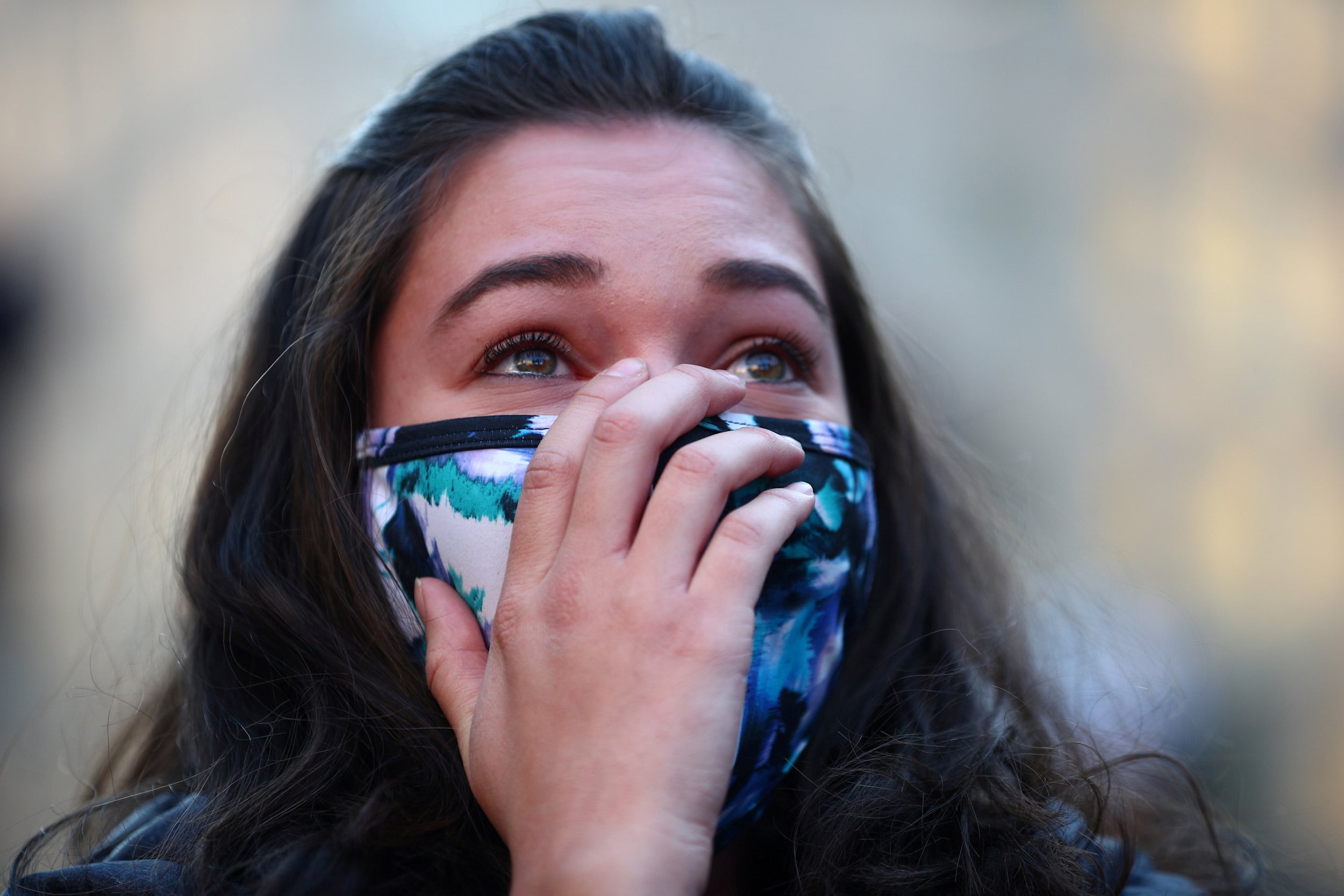 Image: A woman reacts at the news of Democratic U.S. presidential nominee and former Vice President Joe Biden winning Michigan, after Election Day in Washington