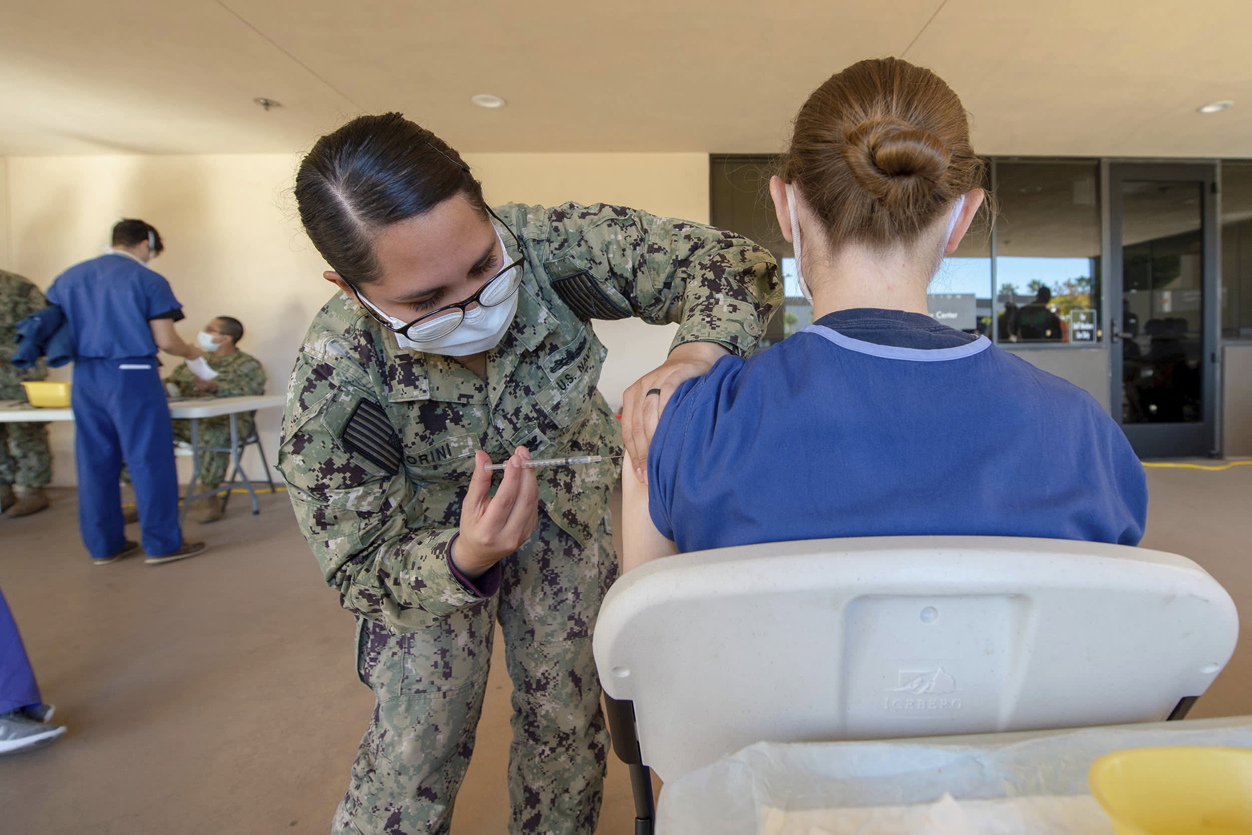 Image: A sailor assigned to Naval Medical Center San Diego (NMCSD), vaccinates a volunteering service member