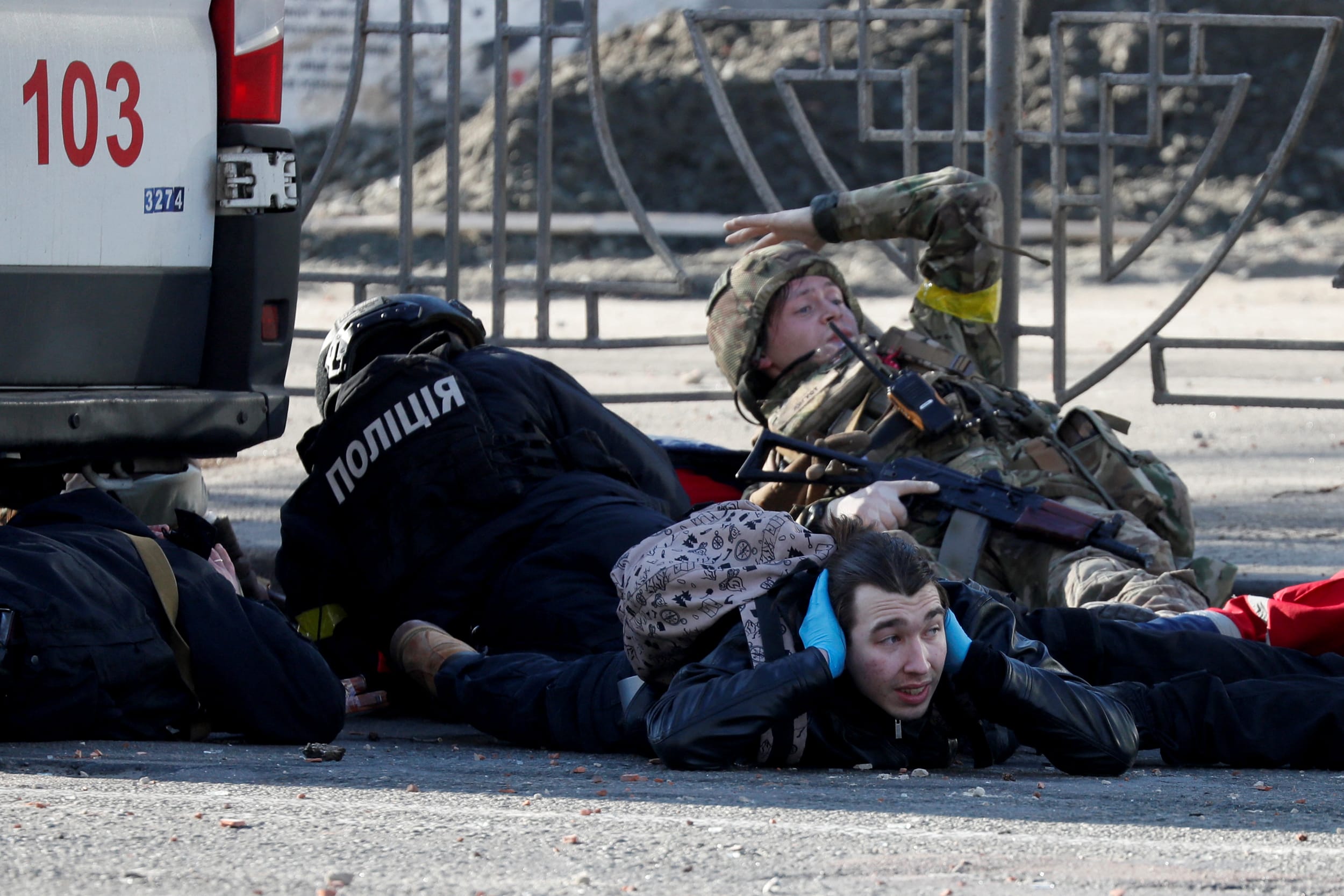 People take cover as an air-raid siren sounds in Kyiv