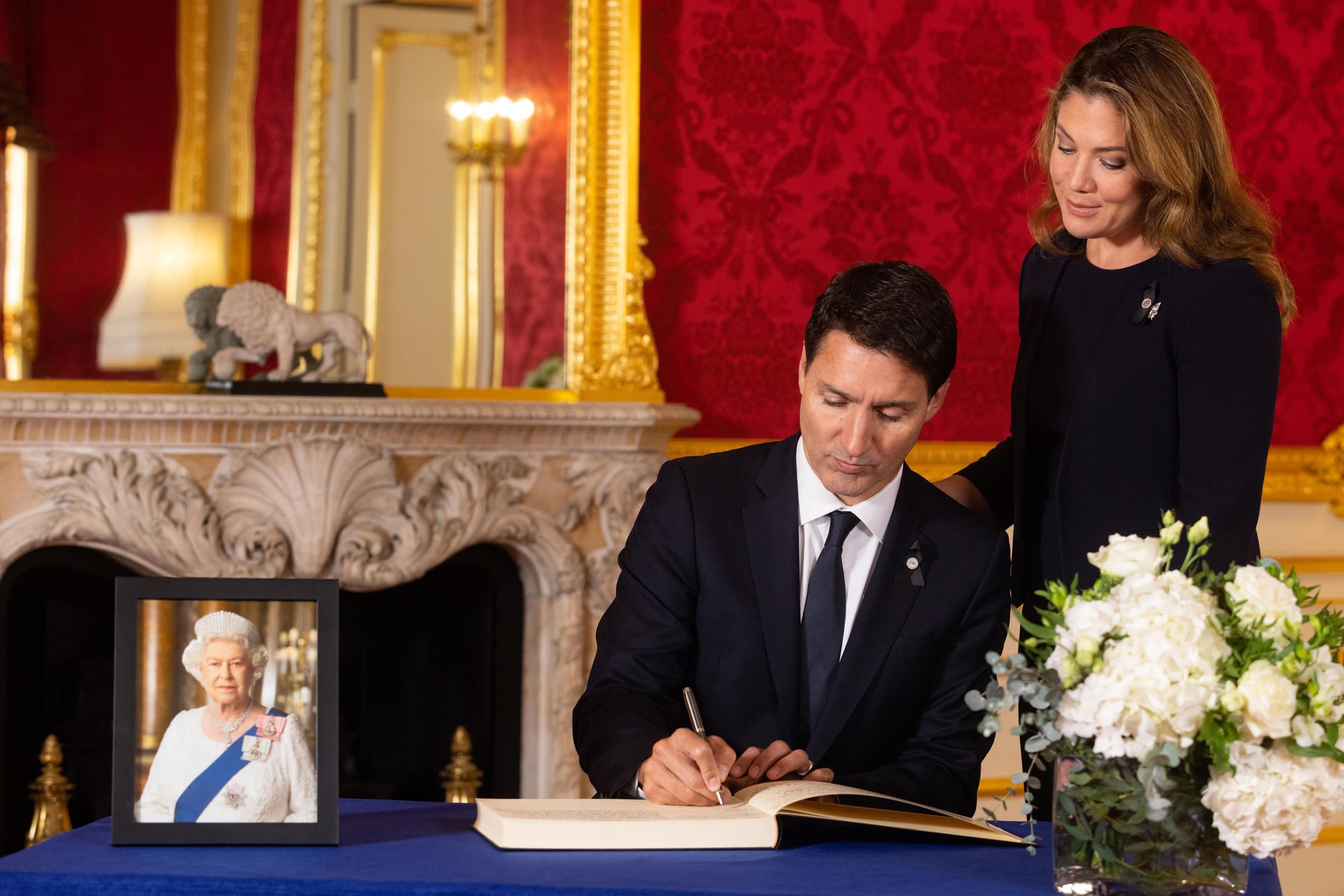 Image: Prime Minister of Canada Justin Trudeau and his wife Sophe Trudeau sign a book of condolence at Lancaster House following the death of Queen Elizabeth II, on Sept. 17, 2022 in London.