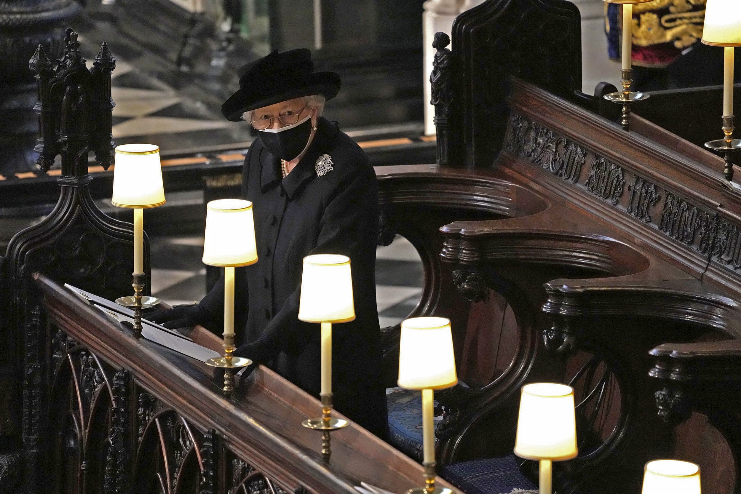 Image: Queen Elizabeth II takes her seat alone in St. George's Chapel during the funeral of Prince Philip, at Windsor Castle, Windsor, England, on April 17, 2021.