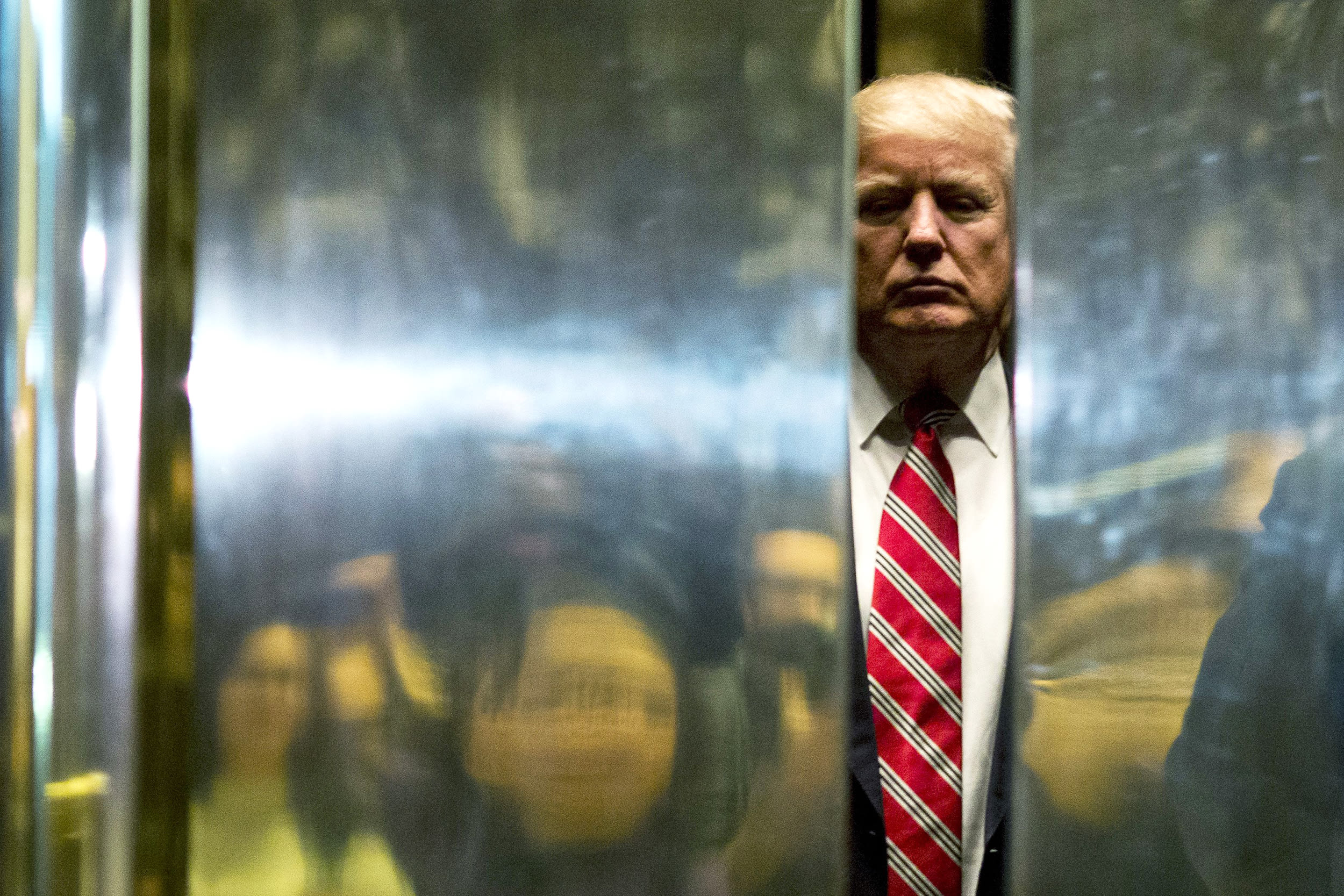 US President-elect Donald Trump boards the elevator after escorting Martin Luther King III to the lobby after meetings at Trump Tower in New York City on January 16, 2017.