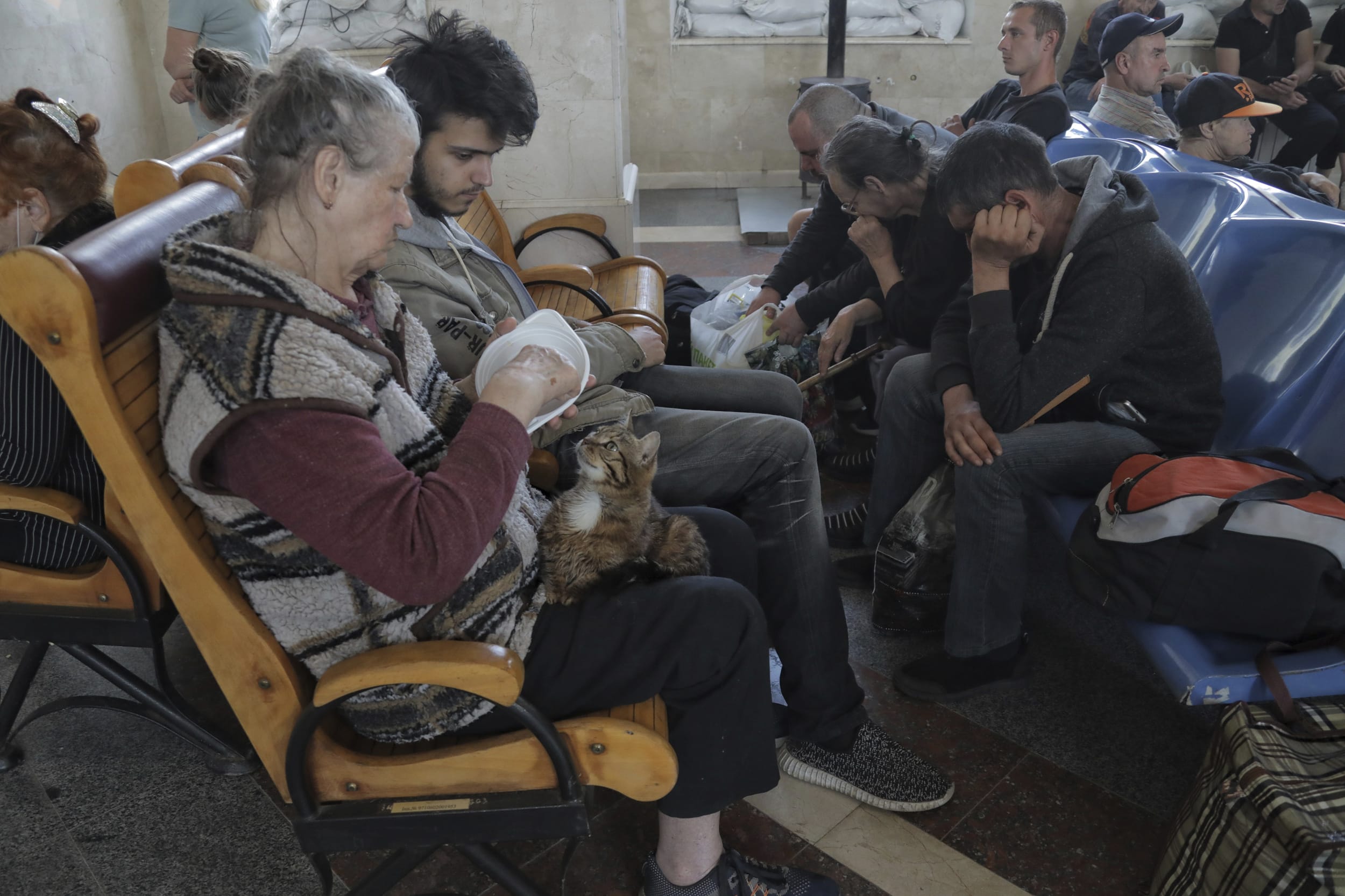 People wait for an evacuation train at a railway station in Kherson