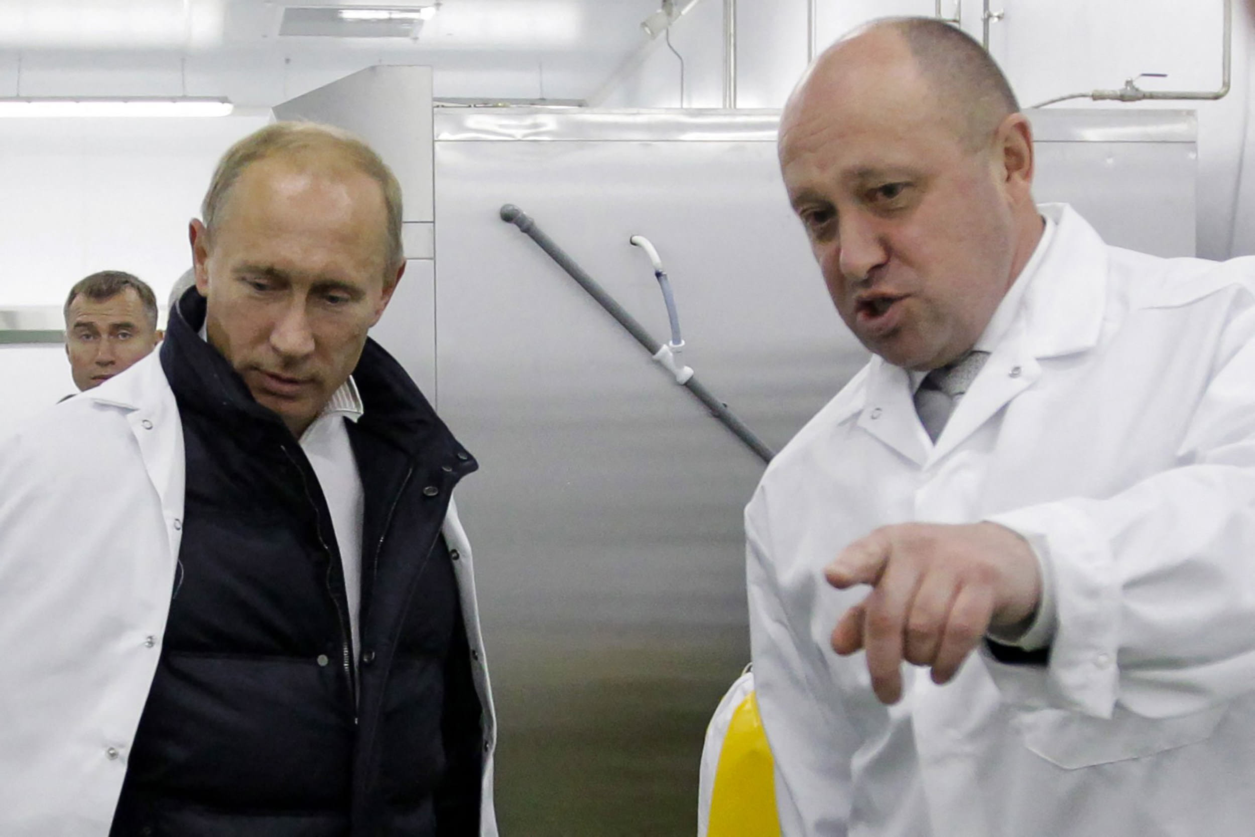 (FILES) Businessman Yevgeny Prigozhin shows Russian Prime Minister Vladimir Putin his school lunch factory outside Saint Petersburg on September 20, 2010. Yevgeny Prigozhin, the head of the Wagner mercenary group, vowed on June 24, 2023 to "go to the end" to topple the Russian military leadership, whom he accused of launching strikes on his men, while the country's prosecutor general said he was under investigation for "armed rebellion". "We will destroy everything that stands in our way," he added in the most audacious challenge to President Vladimir Putin since the start of the offensive in Ukraine last year.