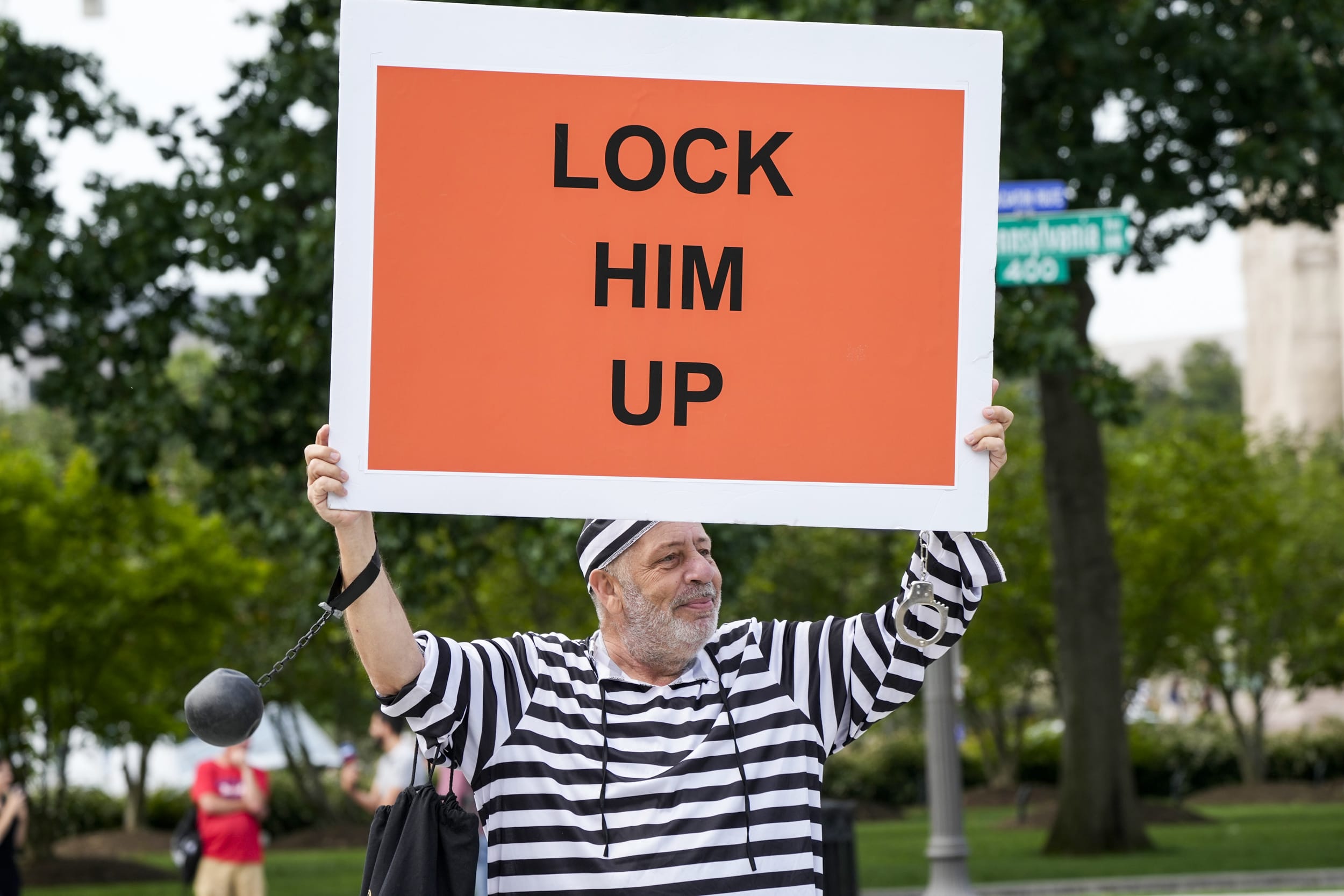 Domenic Santana, 61, of Miami, holds a sign that reads "Lock Him Up" at the E. Barrett Prettyman U.S. Federal Courthouse, on Aug. 3, 2023, in Washington.