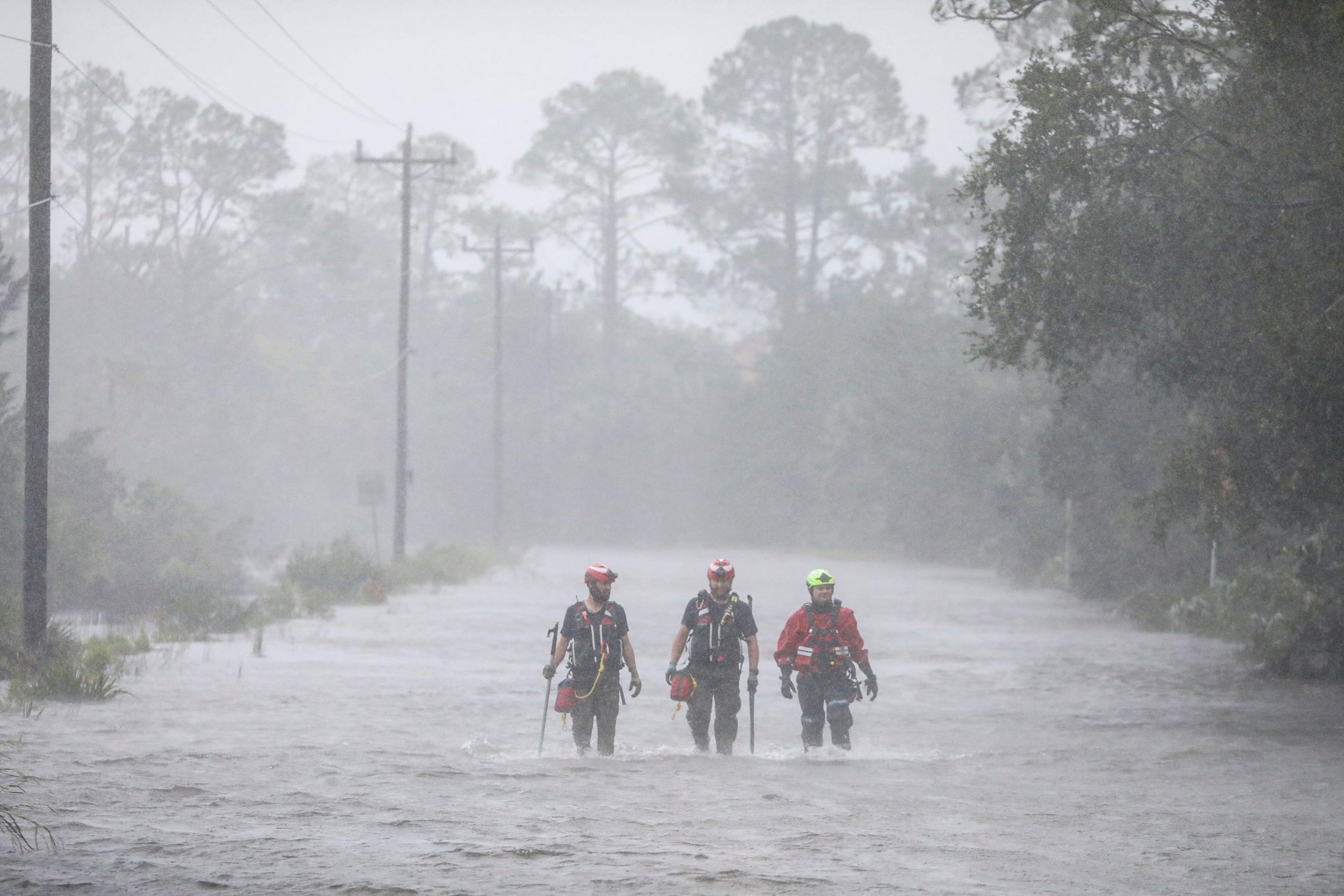 Rescue workers with Tidewater Disaster Response wade through a tidal surge while looking for people in need of help where the Steinhatchee River remained out of its banks on Aug 30, 2023.