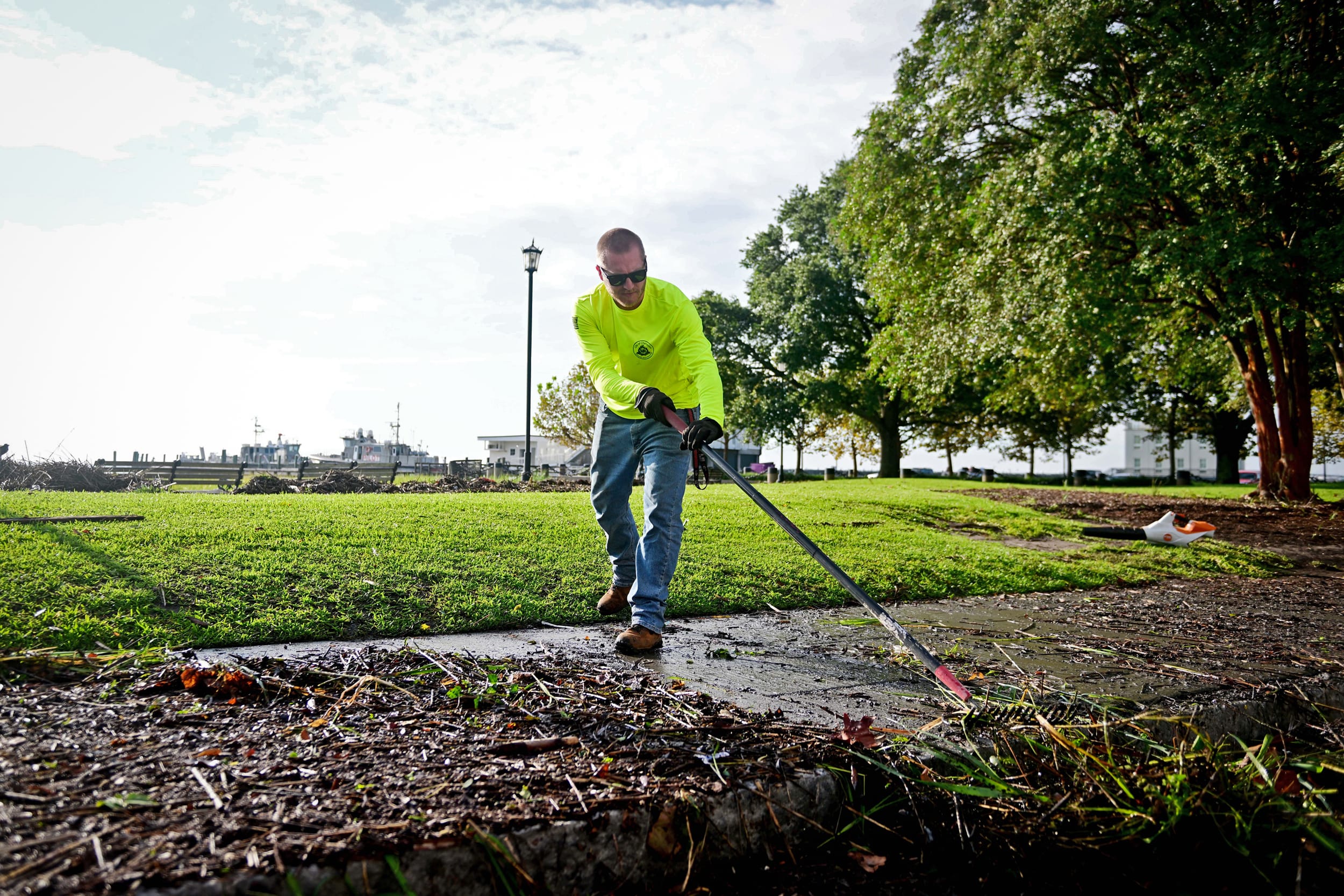 Kenny Wiggins works to clean city sidewalks around Waterfront Park in Charleston, S.C. following Tropical Storm Idalia on Aug. 31, 2023.