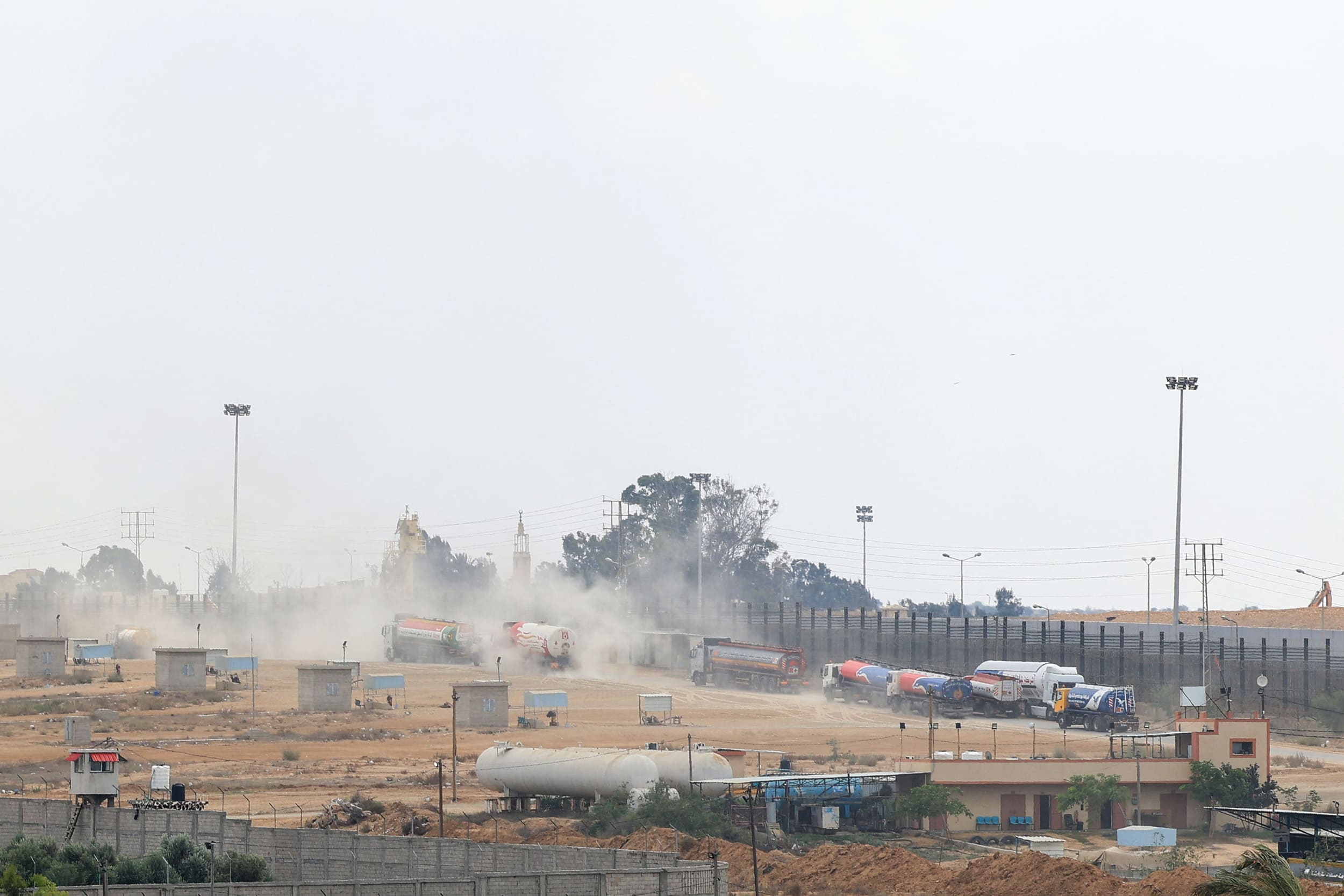 Trucks leave Gaza's Rafah border crossing with Egypt during an Israeli airstrike.
