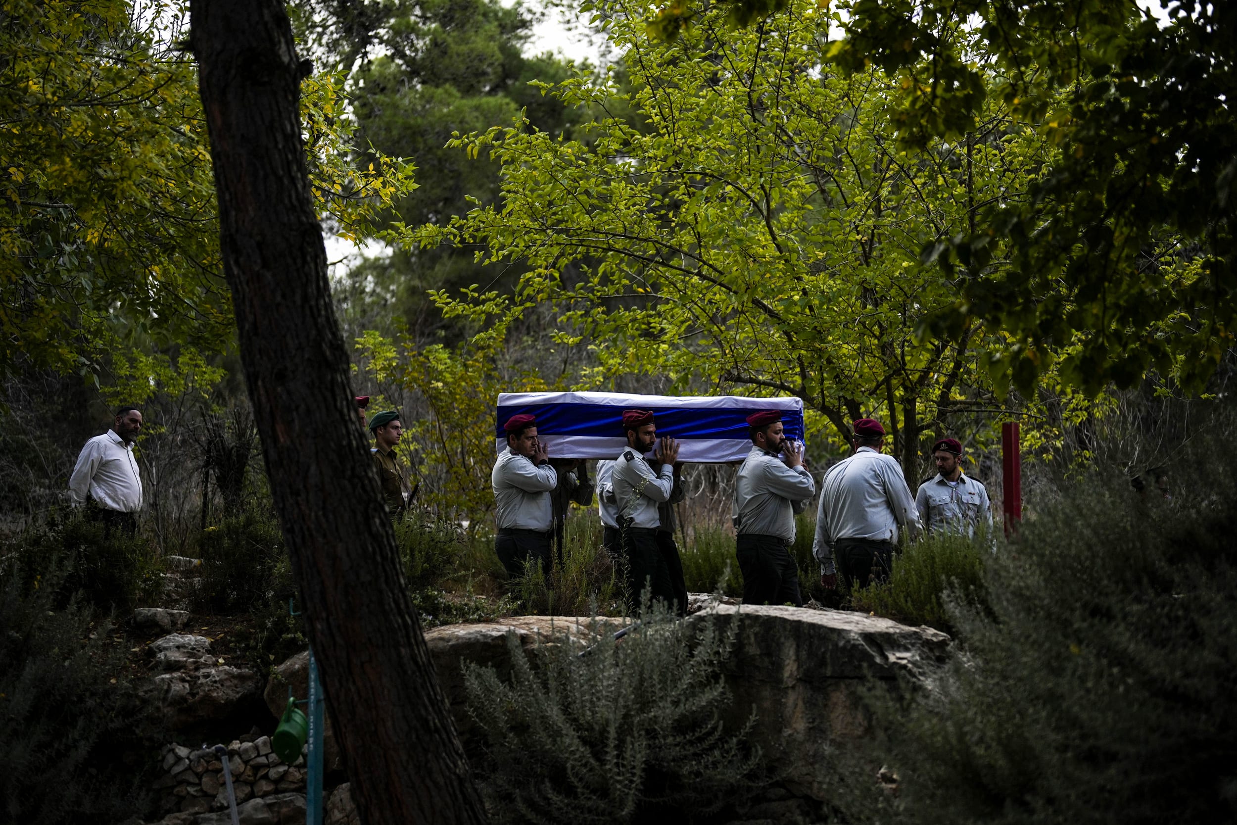 Israeli soldiers carry the flag-covered coffin of Maj. Tal Cohen during his funeral at the Givat Shaul cemetery in Jerusalem.