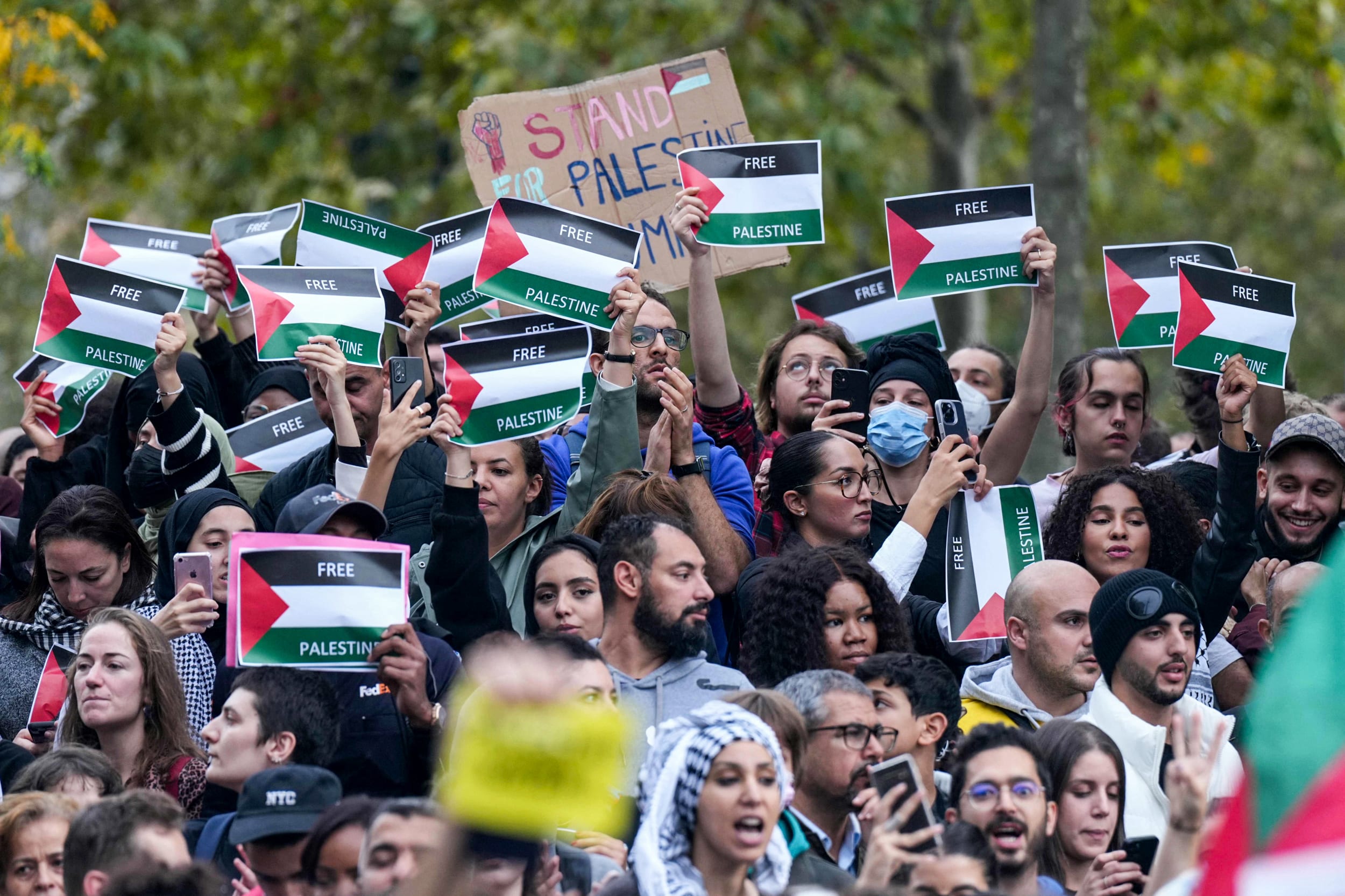 Protestors hold up "Free Palestinian" placards during an unauthorized demonstration in support of Palestinians in Paris on Oct. 12, 2023.