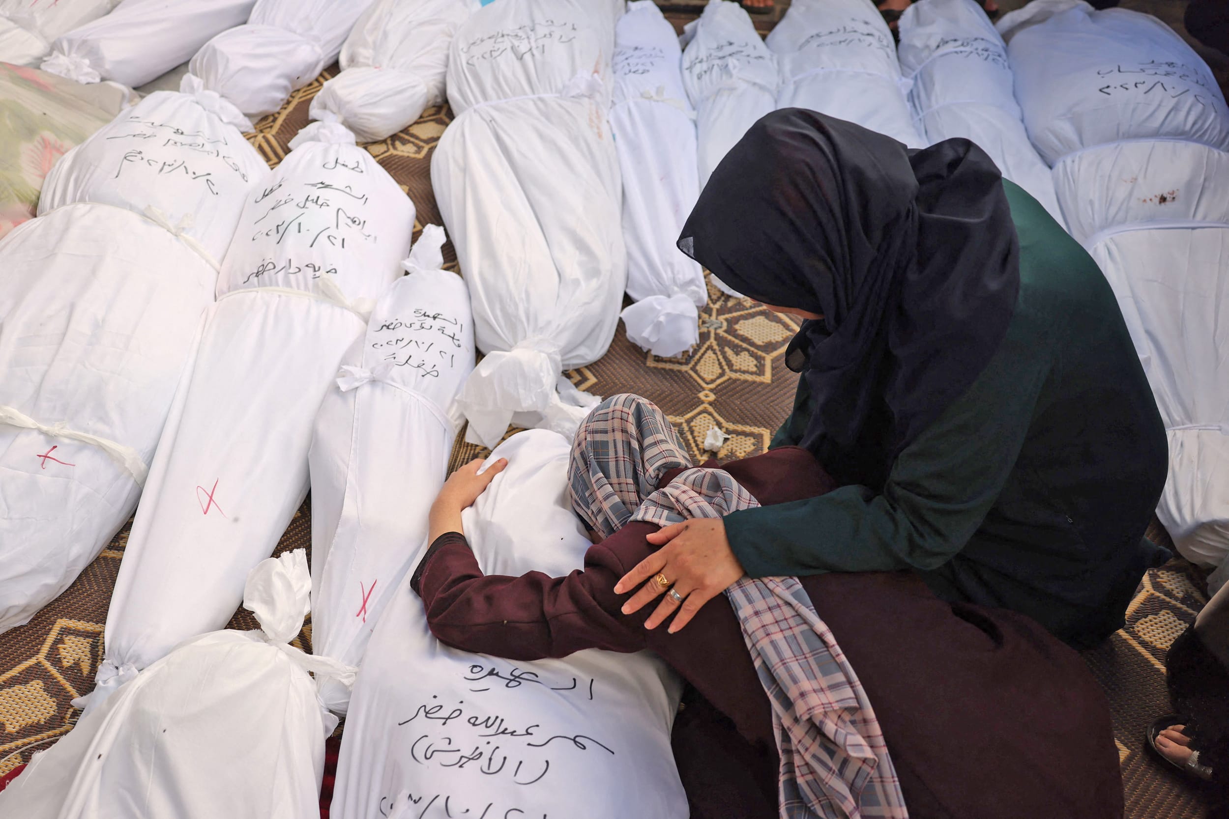 Samia al-Atrash holds the body of her sister, killed in the Israeli bombardment of the Gaza Strip, in Rafah on Saturday, Oct. 21, 2023.