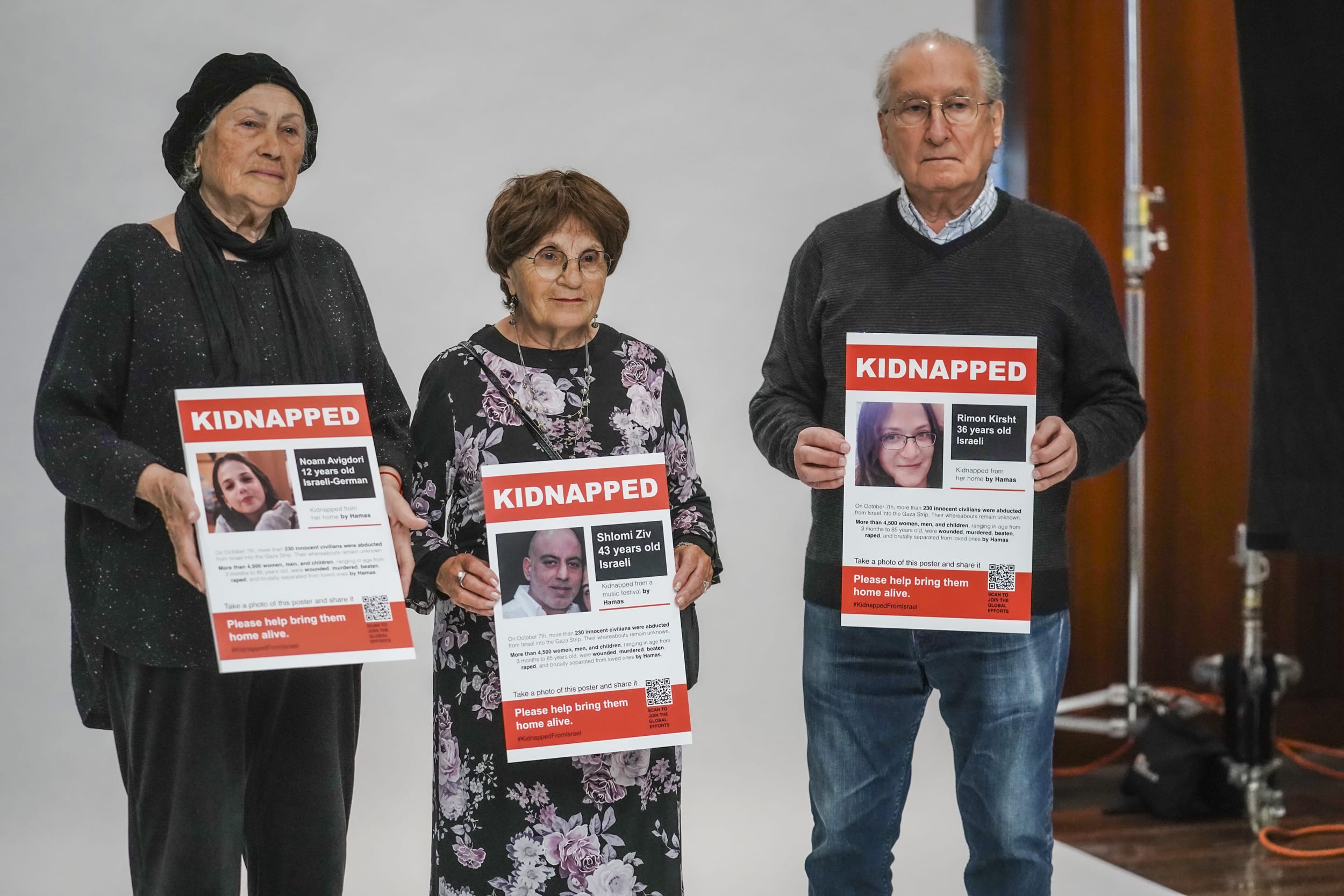 Holocaust survivors, from left, Polina Roytman, Matty Katzman, and Alexander Cherkis hold posters of Israeli hostages being held by Hamas, during a photo shoot of a visual project calling for their release, Wednesday, Nov. 1, 2023, in New York.