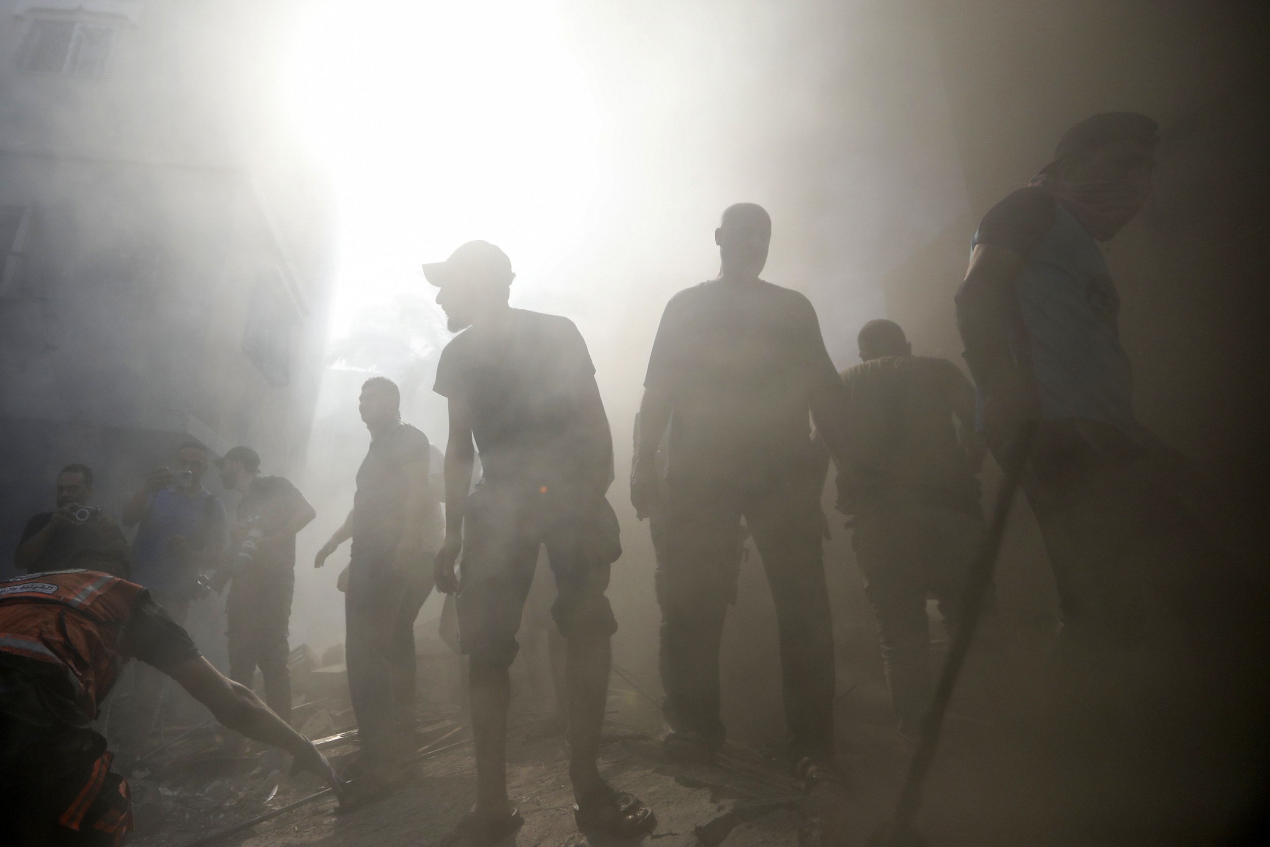 Palestinians look for survivors under the rubble of a destroyed building following an Israeli airstrike in Khan Younis refugee camp, southern Gaza Strip.