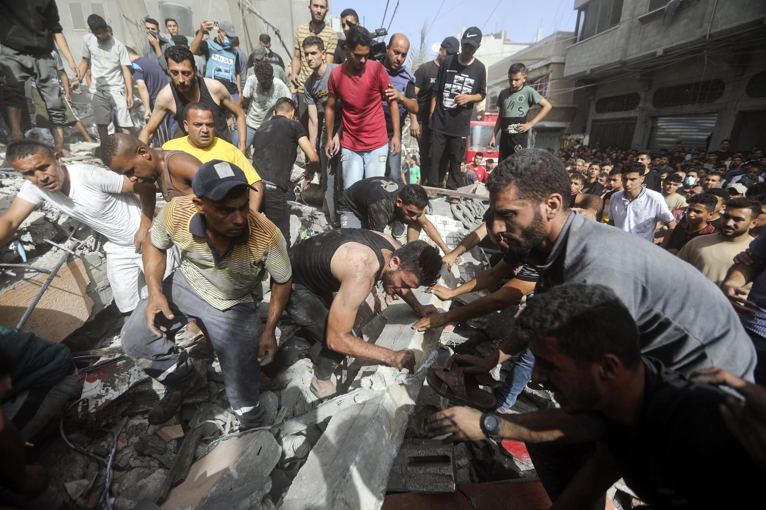 Palestinians look for survivors under the rubble of a destroyed building following an Israeli airstrike in Khan Younis refugee camp, southern Gaza Strip.