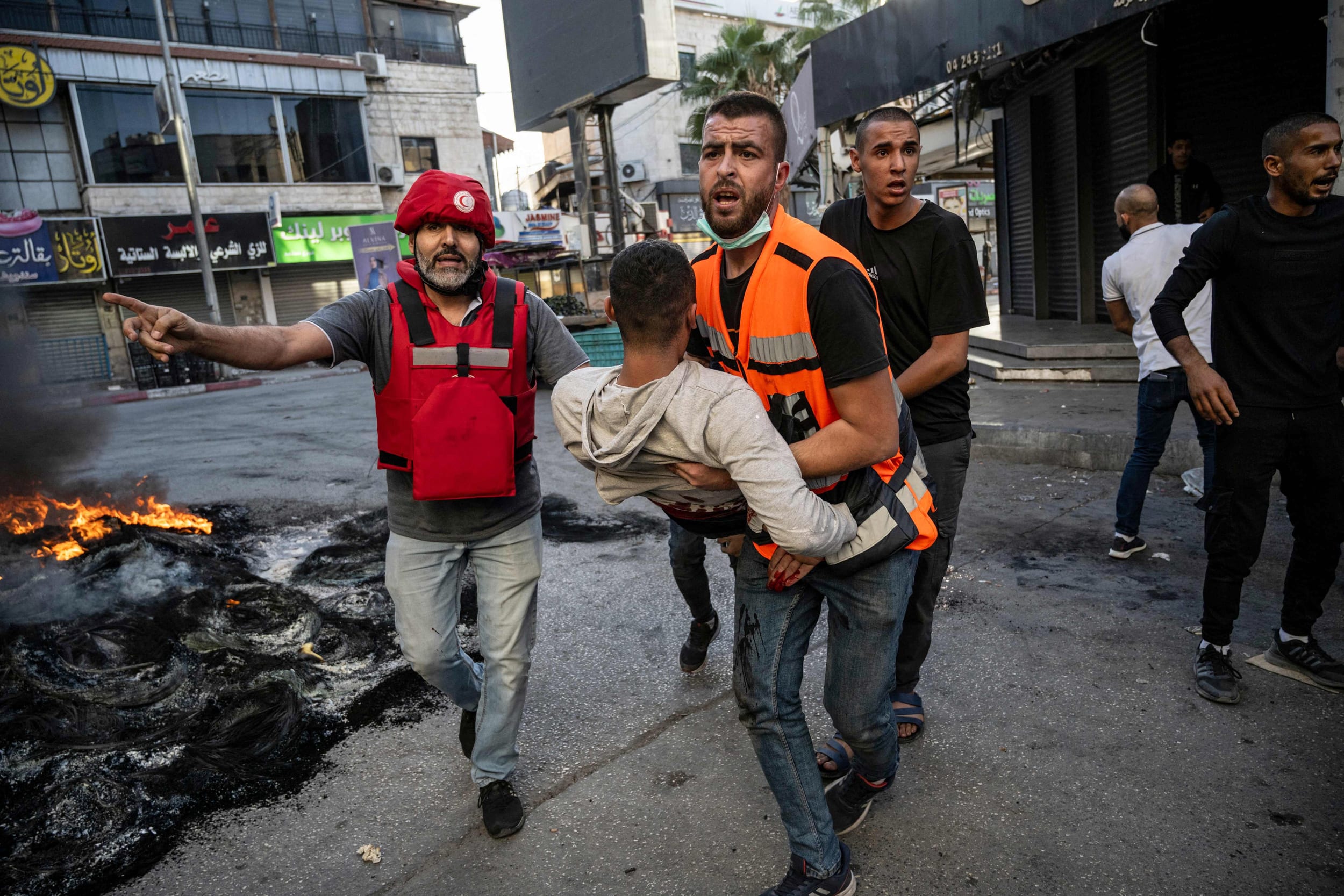 An injured man is carried away after being reportedly shot by Israeli forces during clashes in the occupied West Bank city of Jenin on Nov. 9, 2023. 