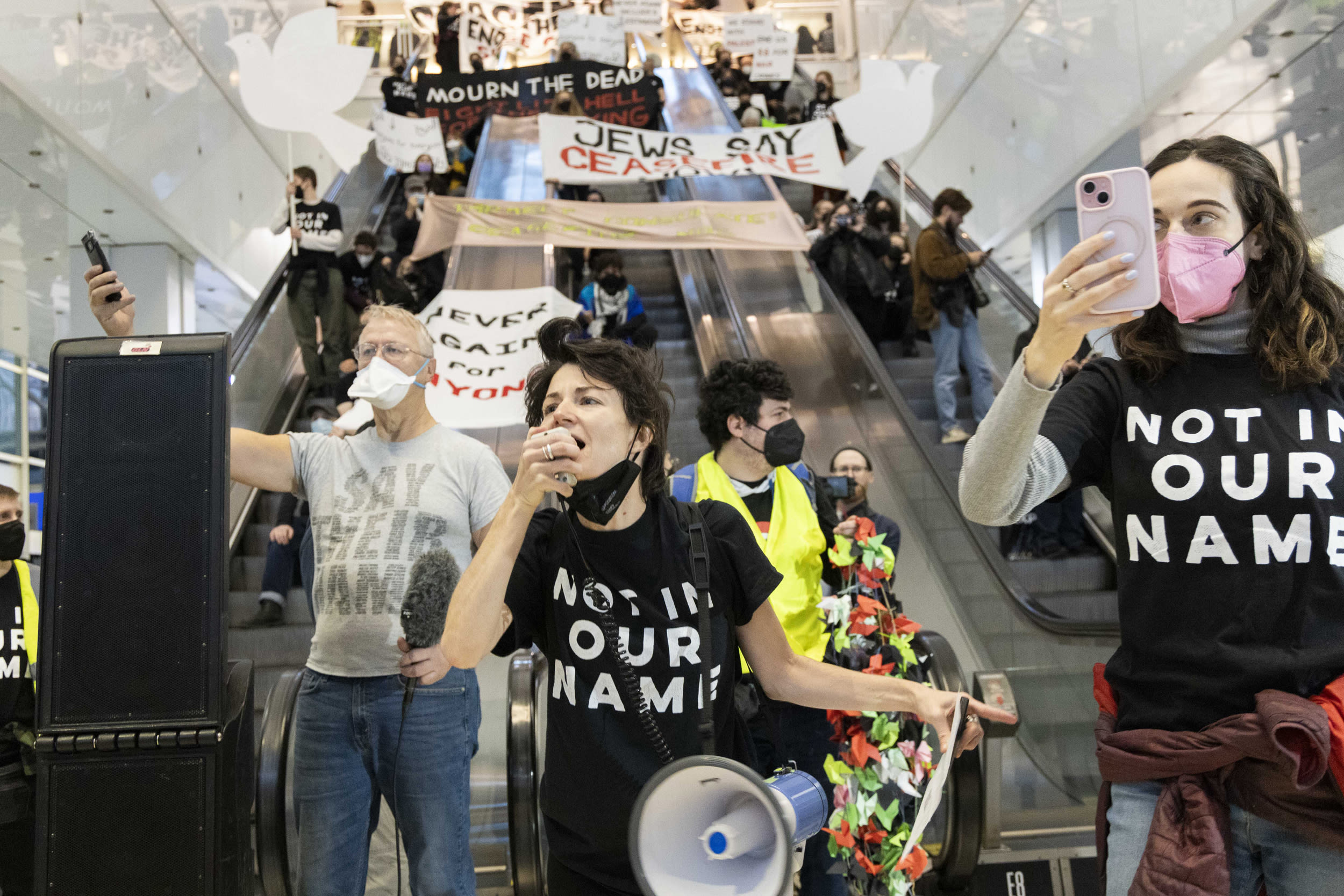 "Midwest Jews For Palestine" activists unveil signs calling for a ceasefire in Gaza on the escalators of the Oglivie Transportation Center in Chicago on Nov. 13, 2023. 