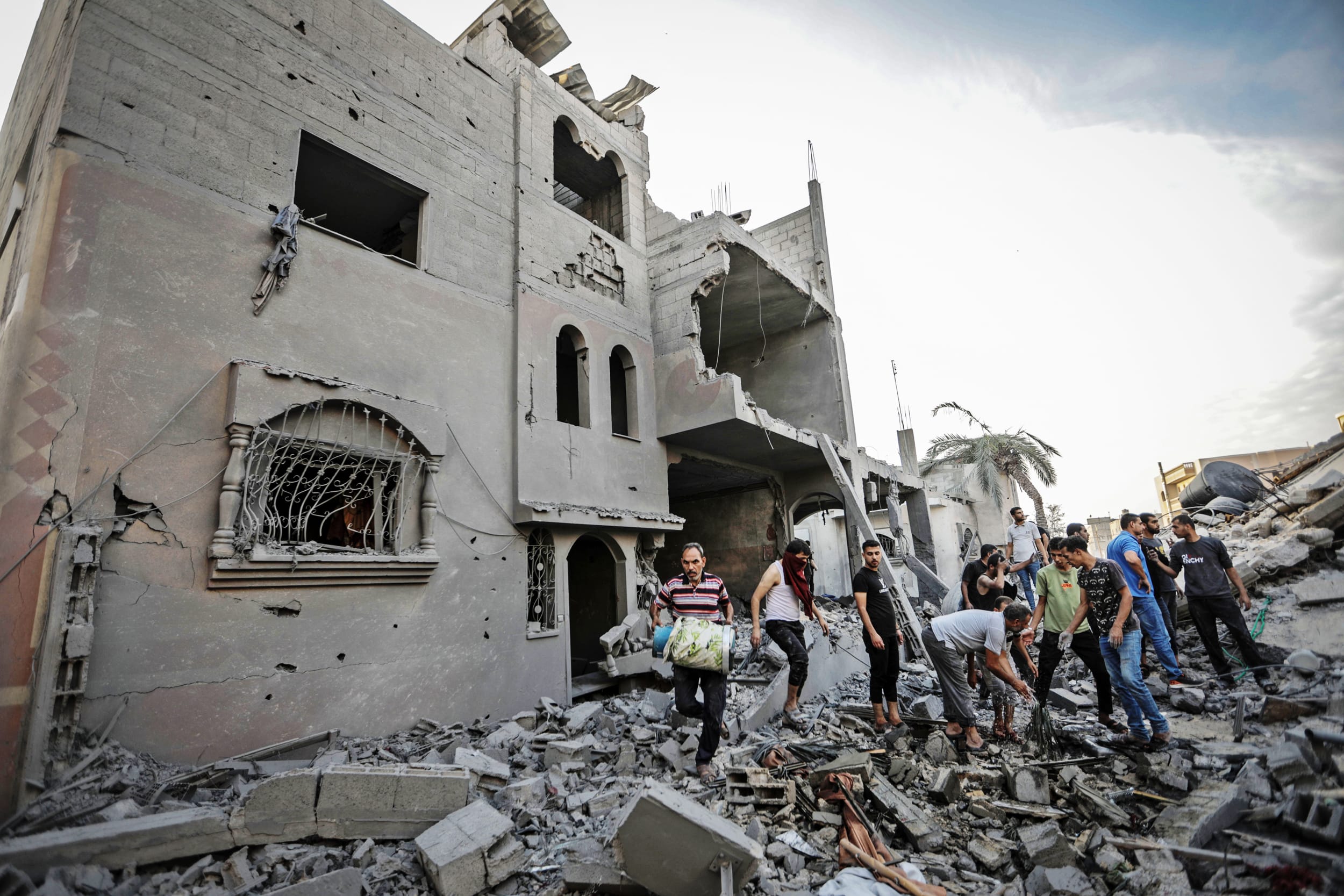 People search through destroyed buildings in Khan Younis in the southern Gaza Strip on Nov. 13, 2023.