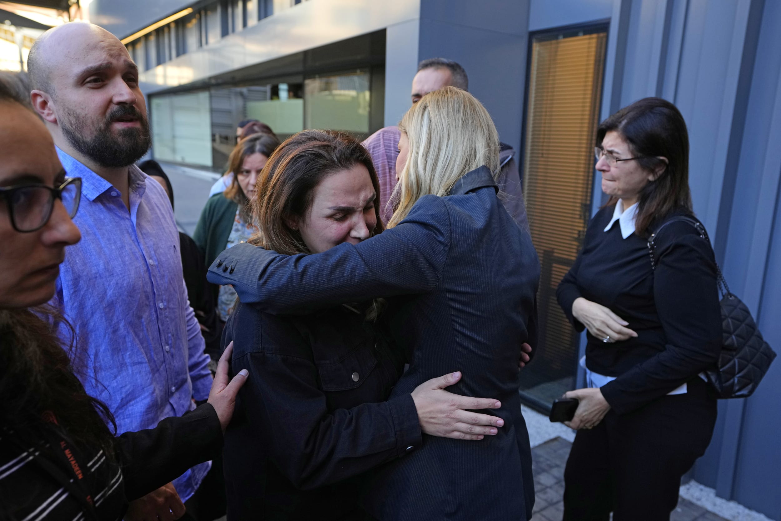 Journalists and family members of the two journalists of pan-Arab TV network Al-Mayadeen who were killed by an Israeli strike mourn as thet wait for the bodies outside the station's headquarters in Beirut on Tuesday, Nov. 21, 2023.