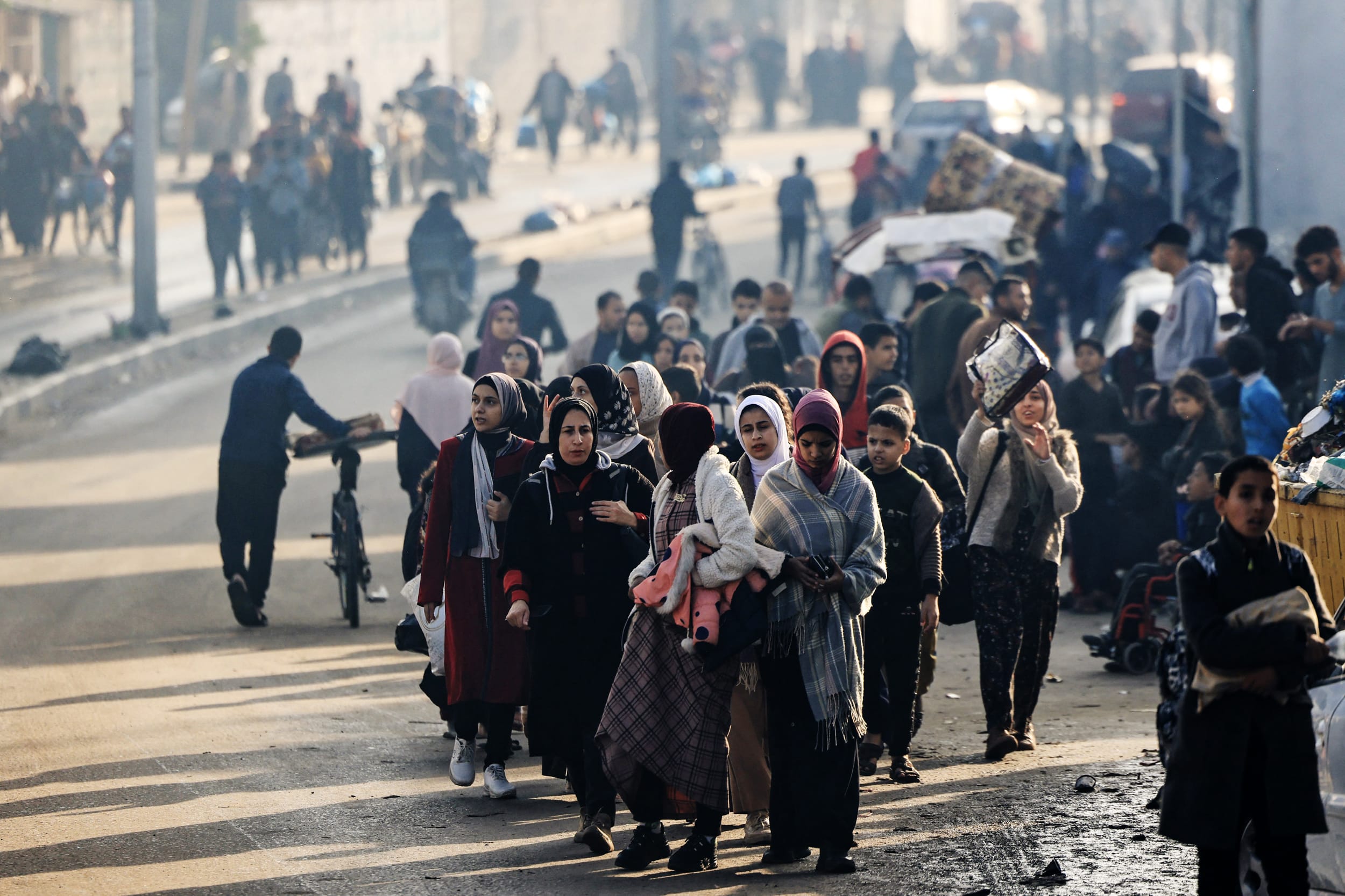 Palestinians walk toward safer areas following the resumption of Israeli strikes on Rafah in the southern Gaza Strip on Dec. 1, 2023.