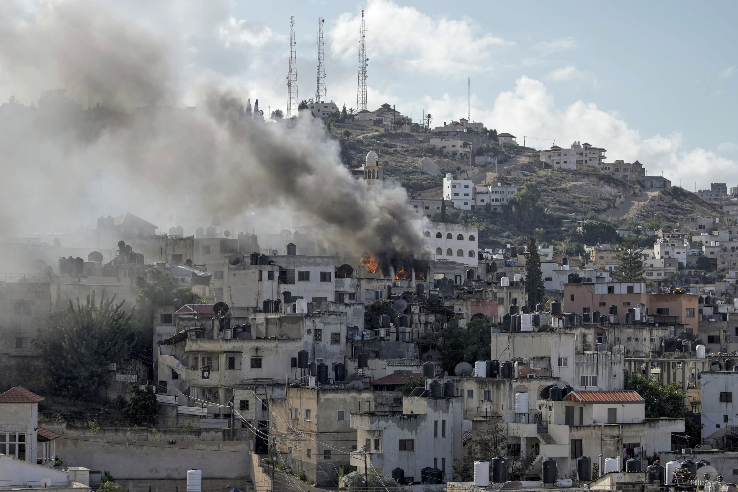 A building burns during an Israeli army operation in Jenin, West Bank, Wednesday, Dec. 13, 2023. 