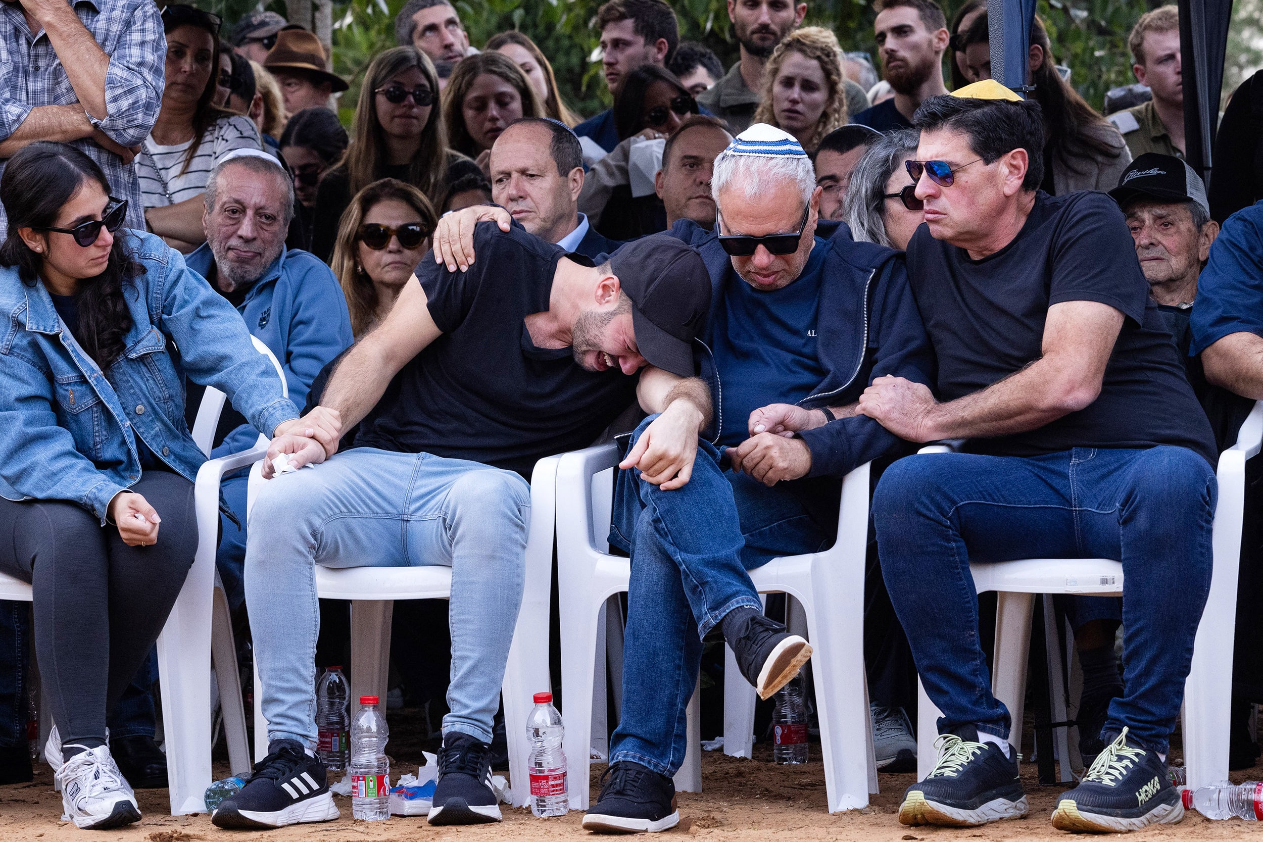 Friend and family mourn during Alon Shamriz' funeral.
